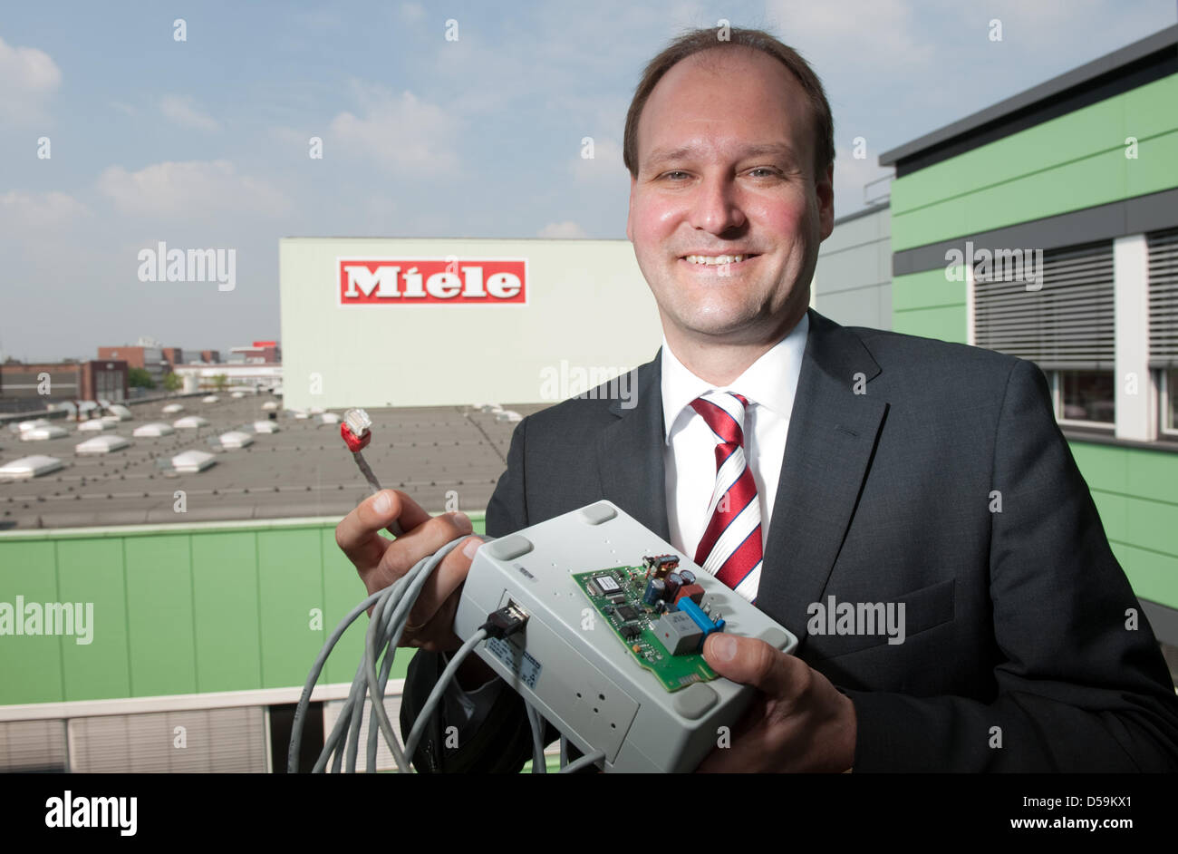 Markus Miele, member of the executive board of the household appliance company Miele, presents electronic accessory devices in Guetersloh, Germany, 25 June 2010. The devices can be used to connect household appliances to the internet via the so-called 'Smart Grid' technology so that the appliances can be controlled from a smartphone. At a press conference, the family business annou Stock Photo