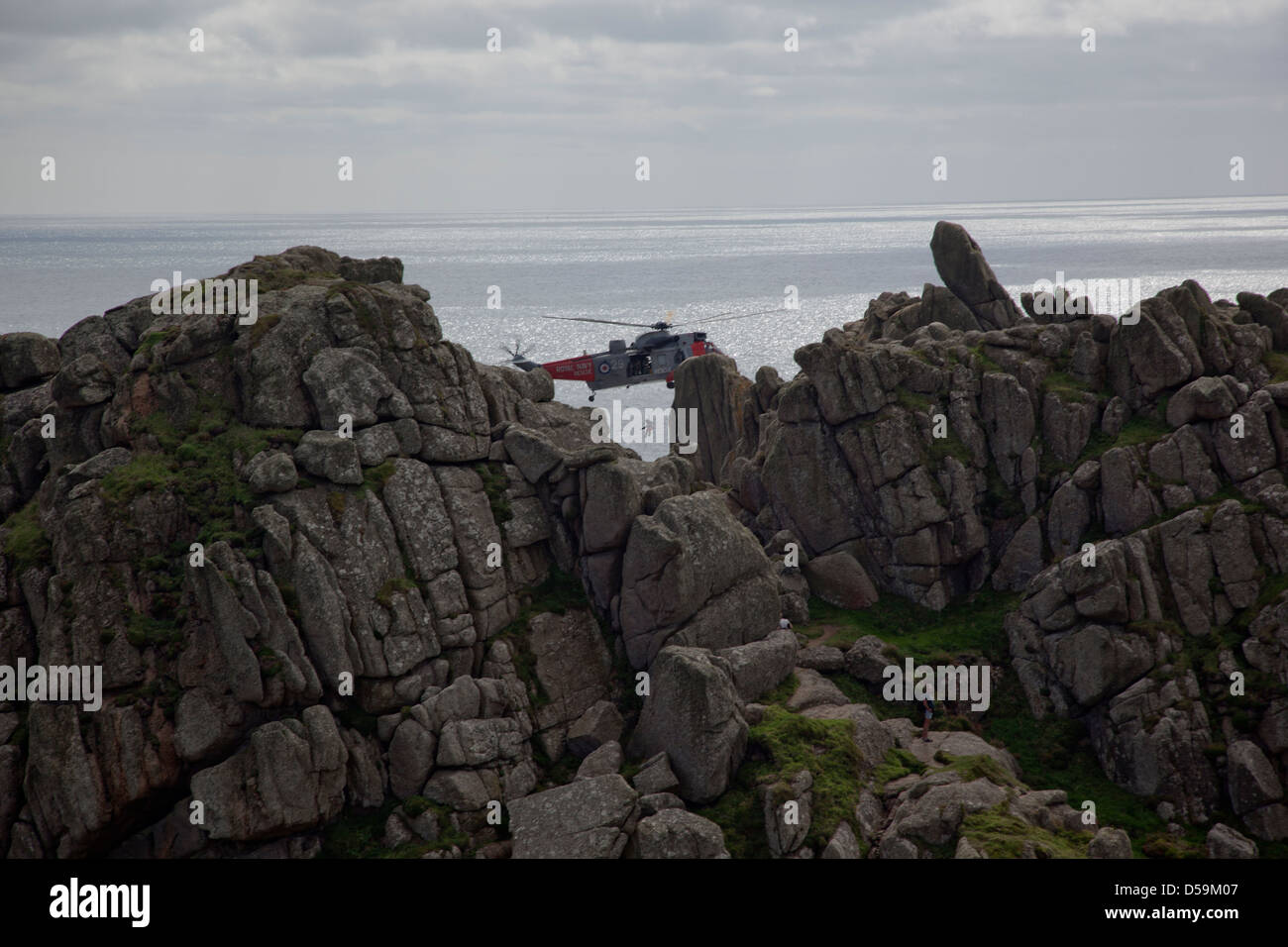 RAF Air Sea Rescue Sea King helicopter in action at Logan Rock, Penzance, Cornwall, UK Stock Photo