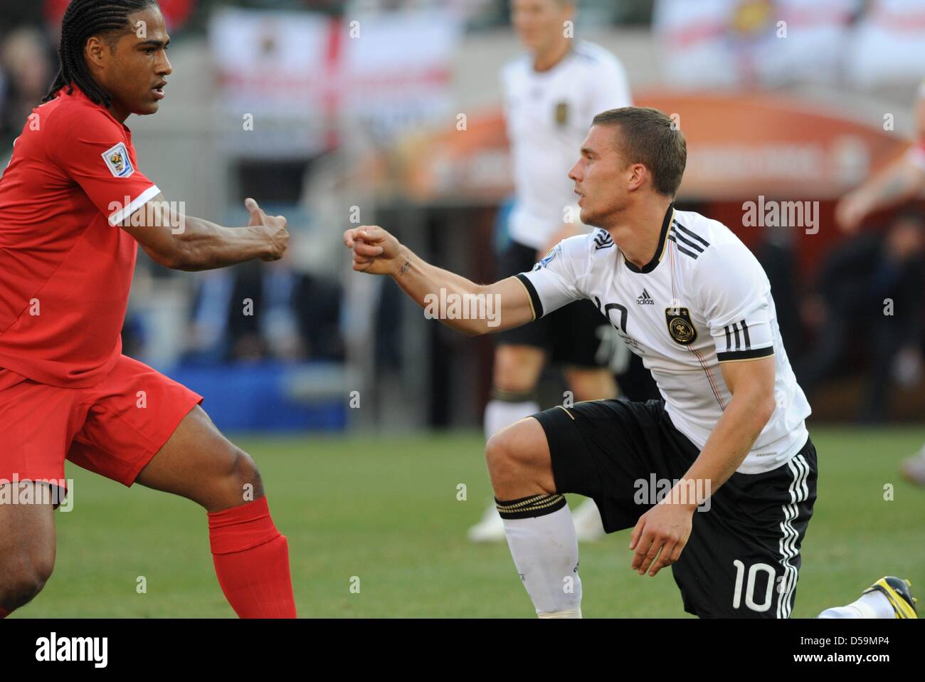 Germany's Lukas Podolski is helped up by England's Glen Johnson during the 2010 FIFA World Cup Round of Sixteen match between Germany and England at the Free State Stadium in Bloemfontein, South Africa 27 June 2010. Photo: Marcus Brandt dpa - Please refer to http://dpaq.de/FIFA-WM2010-TC Stock Photo