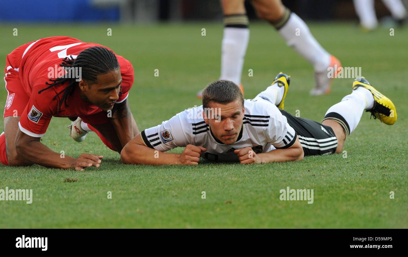 Germany's Lukas Podolski and England's Glen Johnson on the ground during the 2010 FIFA World Cup Round of Sixteen match between Germany and England at the Free State Stadium in Bloemfontein, South Africa 27 June 2010. Photo: Marcus Brandt dpa - Please refer to http://dpaq.de/FIFA-WM2010-TC Stock Photo