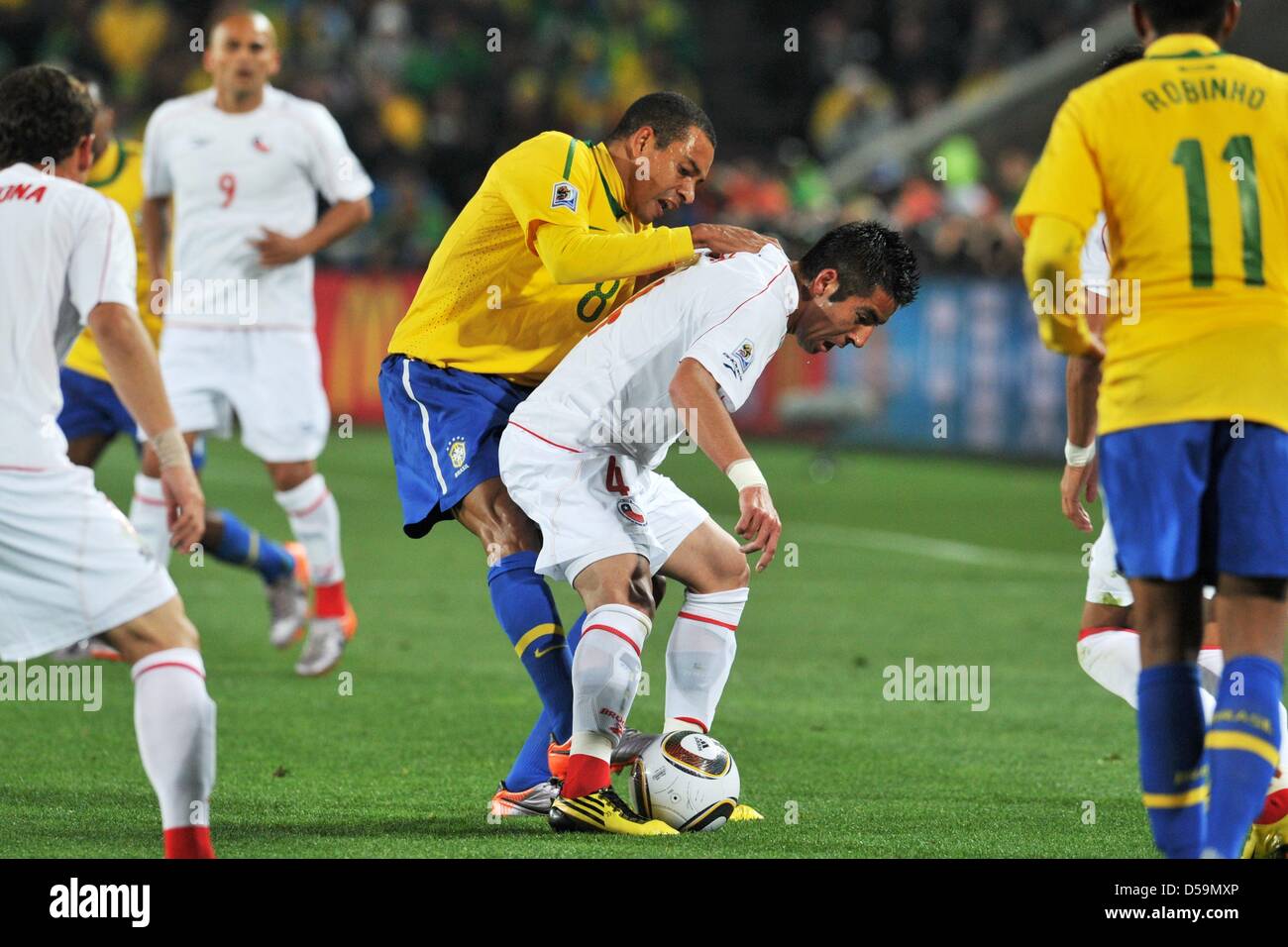 Gilberto Silva (C-L) of Brazil vies with Mauricio Isla of Chile during the national anthem pror the 2010 FIFA World Cup Round of Sixteen match between Brazil and Chile at the Ellis Park Stadium in Johannesburg, South Africa 28 June 2010. Photo: Bernd Weissbrod dpa - Please refer to http://dpaq.de/FIFA-WM2010-TC  +++(c) dpa - Bildfunk+++ Stock Photo