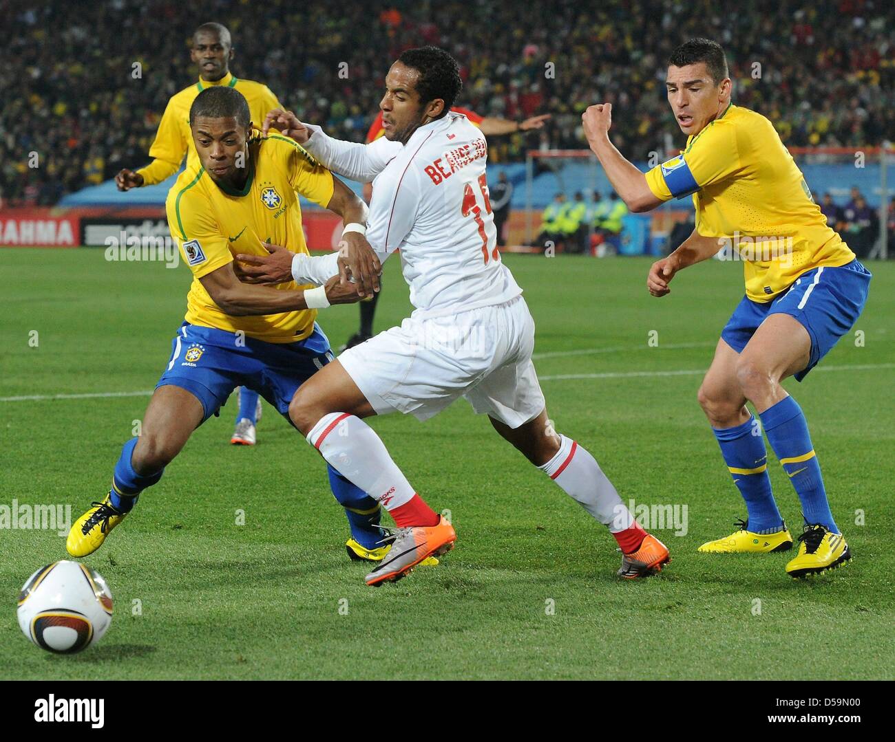 Brazil's Michel Bastos (L) and Lucio vie for the ball with Chile's Jean Beausejour during the 2010 FIFA World Cup Round of Sixteen match between Brazil and Chile at the Ellis Park Stadium in Johannesburg, South Africa 28 June 2010. Photo: Marcus Brandt dpa - Please refer to http://dpaq.de/FIFA-WM2010-TC  +++(c) dpa - Bildfunk+++ Stock Photo