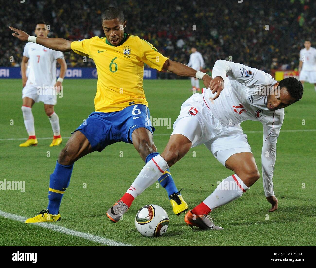 Brazil's Michel Bastos (L) vies for the ball with Chile's Jean Beausejour during the 2010 FIFA World Cup Round of Sixteen match between Brazil and Chile at the Ellis Park Stadium in Johannesburg, South Africa 28 June 2010. Photo: Marcus Brandt dpa - Please refer to http://dpaq.de/FIFA-WM2010-TC  +++(c) dpa - Bildfunk+++ Stock Photo