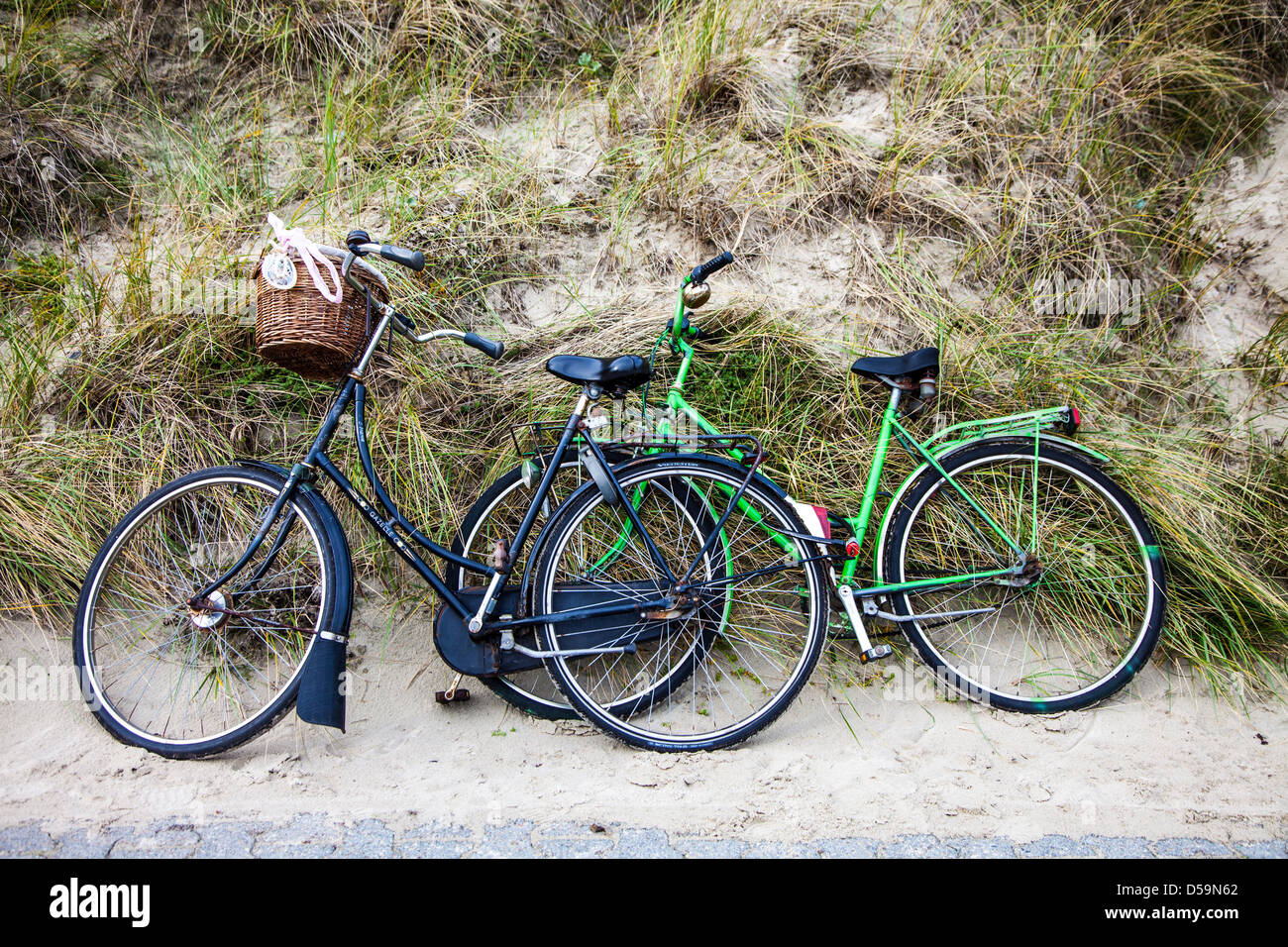Bicycles leaning at a dune of a beach, North Sea Island, East Frisian, Spiekeroog, Germany Stock Photo