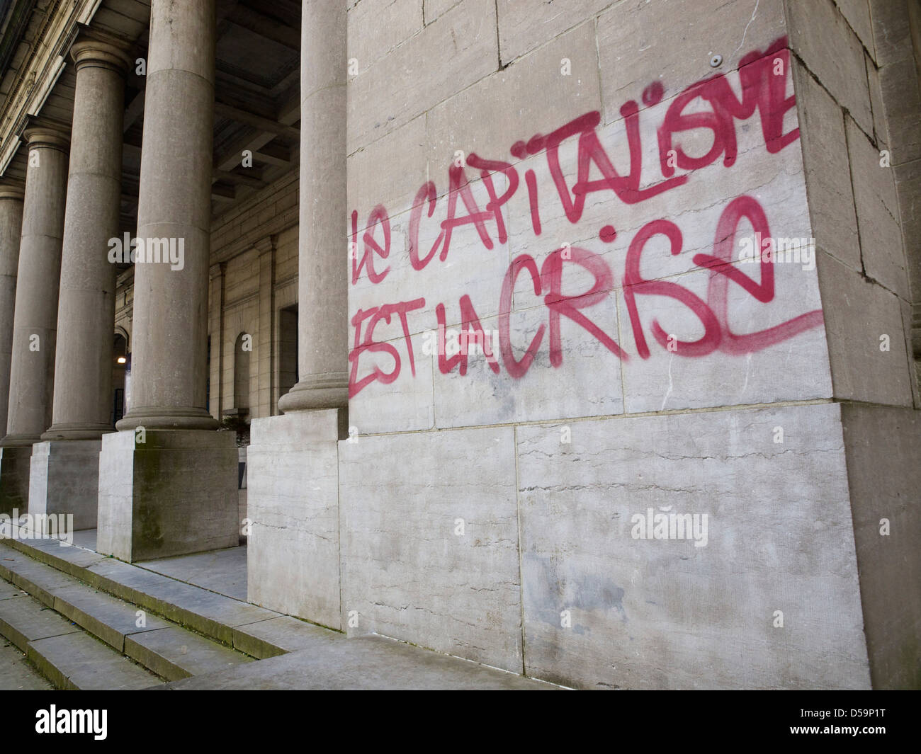 Slogan in French language: capitalism is crisis on the wall of a Brussels Museum. Stock Photo
