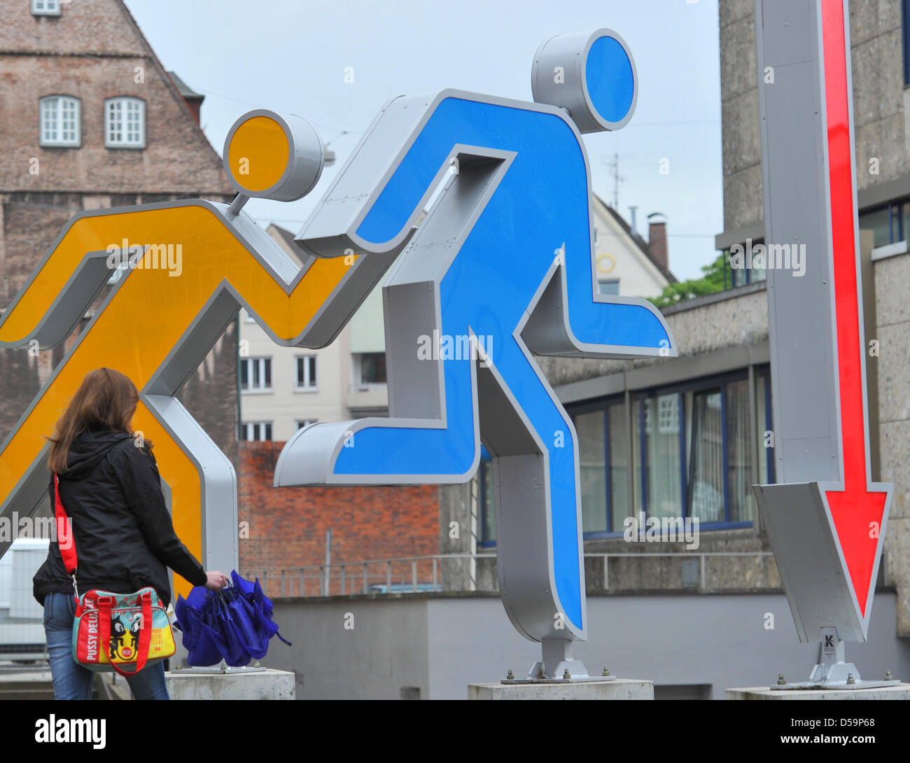 A woman passes by an overdimensional pictogram in Ulm, Germany, 17 June 2010. The pictograms were designed by Ottl Aicher of the Hochschule fuer Gestaltung (HfG), which is the Ulm School of Design. The HfG  was considered one of the leading schools of design in Germany until its closing in 1968. The former building of the HfG is now intended to become a centre for design. Photo: St Stock Photo