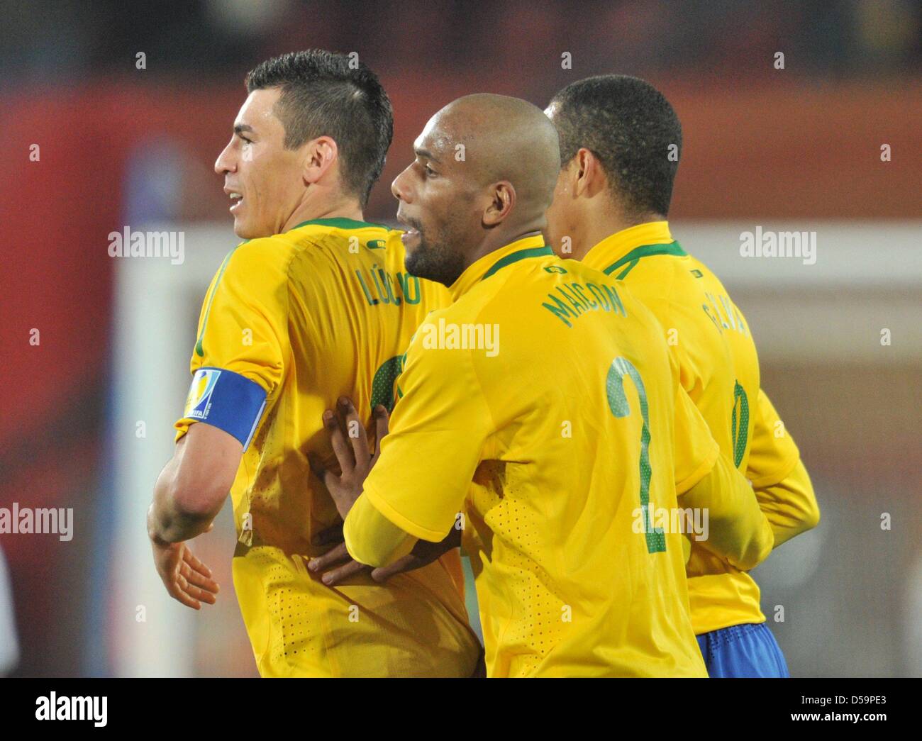 Lucio (L-R), Maicon and Gilberto Silva of Brazil celebrate after the final whistle of the 2010 FIFA World Cup Round of Sixteen match between Brazil and Chile at the Ellis Park Stadium in Johannesburg, South Africa 28 June 2010. Photo: Bernd Weissbrod dpa - Please refer to http://dpaq.de/FIFA-WM2010-TC Stock Photo