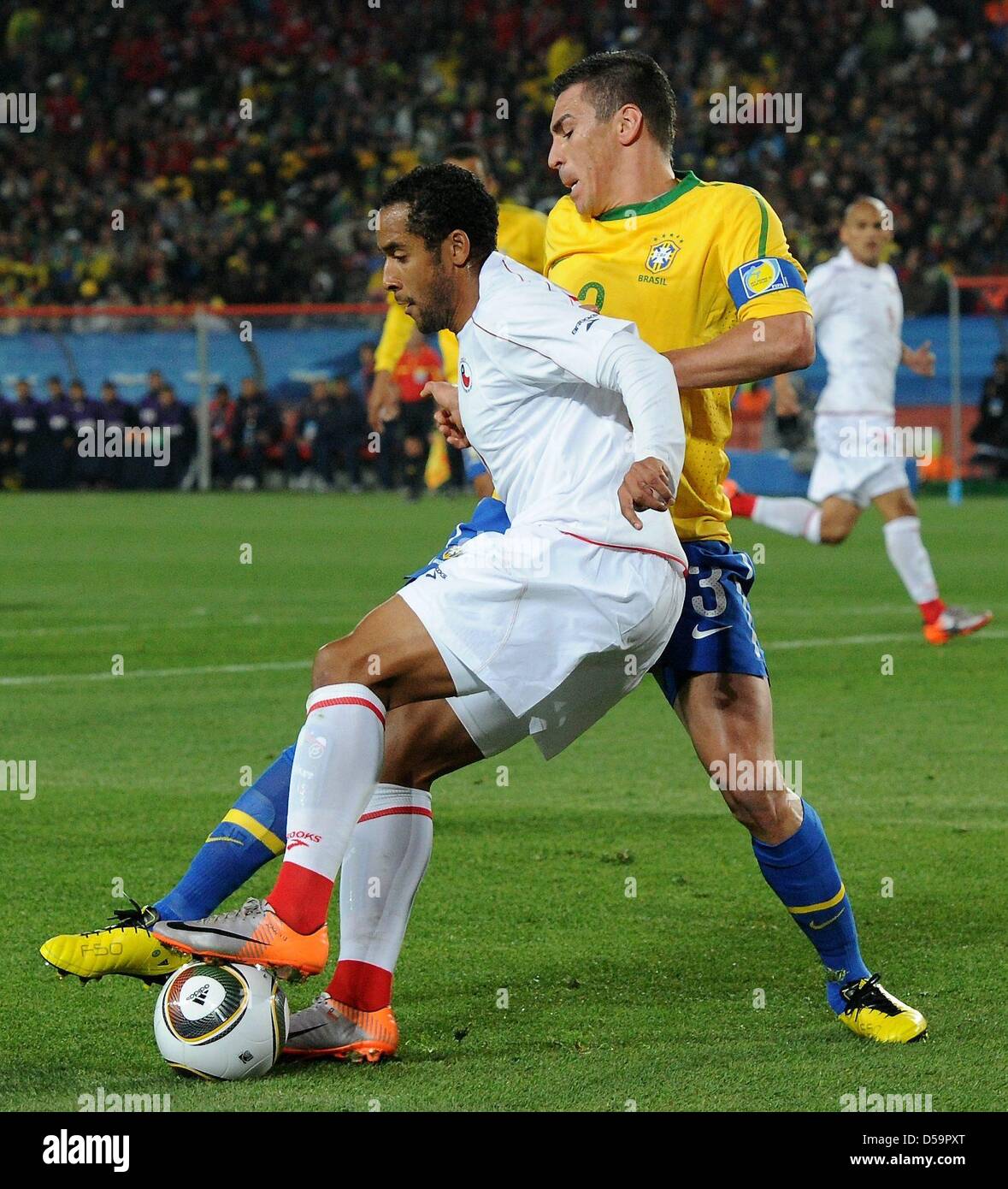 Brazil's Lucio vies for the ball with Chile's Jean Beausejour during the 2010 FIFA World Cup Round of Sixteen match between Brazil and Chile at the Ellis Park Stadium in Johannesburg, South Africa 28 June 2010. Photo: Marcus Brandt dpa - Please refer to http://dpaq.de/FIFA-WM2010-TC Stock Photo
