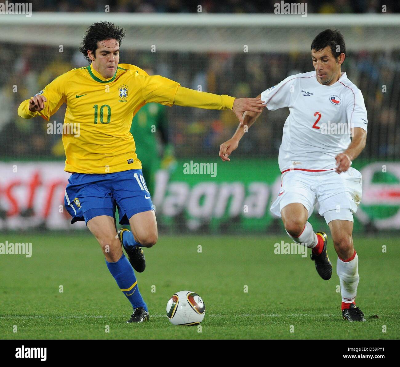 Brazil's Kaka (L) vies for the ball with Chile's Ismael Fuentes during the 2010 FIFA World Cup Round of Sixteen match between Brazil and Chile at the Ellis Park Stadium in Johannesburg, South Africa 28 June 2010. Photo: Marcus Brandt dpa - Please refer to http://dpaq.de/FIFA-WM2010-TC Stock Photo