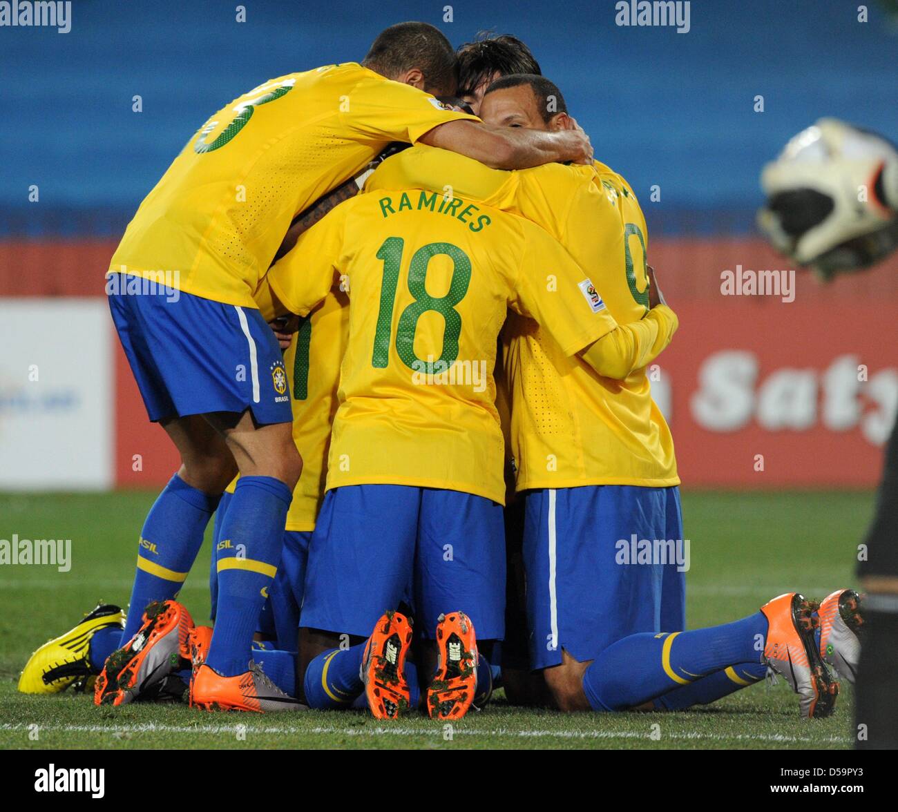 Brazil's Dani Alves (L-R), Ramires and Luis Fabiano celebrate a goal during the 2010 FIFA World Cup Round of Sixteen match between Brazil and Chile at the Ellis Park Stadium in Johannesburg, South Africa 28 June 2010. Photo: Marcus Brandt dpa - Please refer to http://dpaq.de/FIFA-WM2010-TC Stock Photo