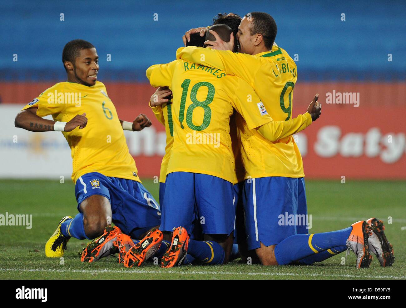 Brazil's Michel Bastos (L-R), Ramires and Luis Fabiano celebrate a goal during the 2010 FIFA World Cup Round of Sixteen match between Brazil and Chile at the Ellis Park Stadium in Johannesburg, South Africa 28 June 2010. Photo: Marcus Brandt dpa - Please refer to http://dpaq.de/FIFA-WM2010-TC Stock Photo