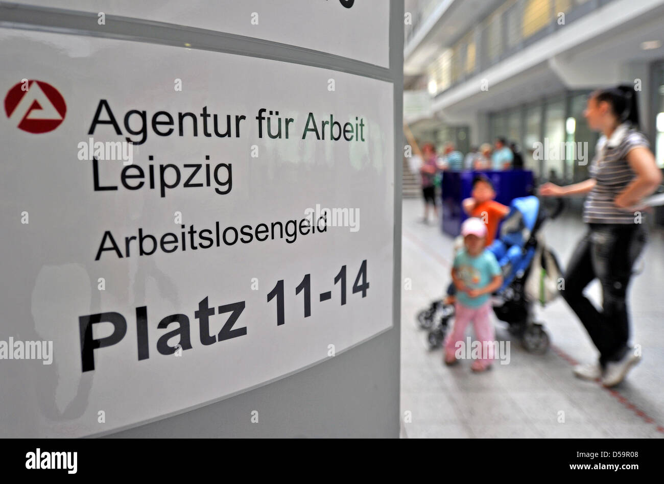 Customers of the local job centre queue in Leipzig, Germany, 30 June 2010. Unemployment rate has