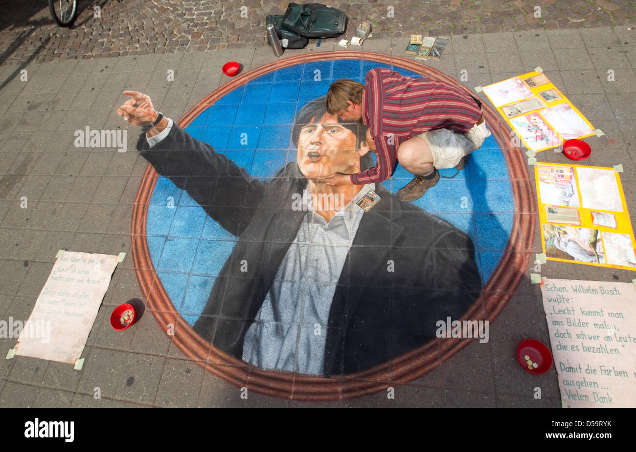The street artist Ulrich Zessin paints a picture of the German national team's soccer coach Joachim Loew on a pavement in Muenster, Germany on 1 July 2010. It took the artist about 30 hours to finish the picture which he painted with pastel chalk. Photo: Friso Gentsch Stock Photo
