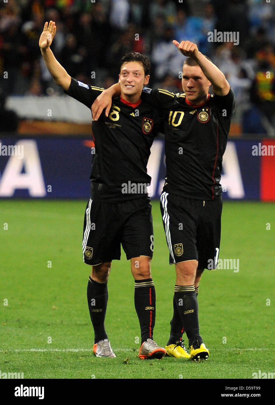 Germany's Mesut Oezil (L) and Lukas Podolski celebrate after the 2010 FIFA World Cup quarterfinal match between Argentina and Germany at the Green Point Stadium in Cape Town, South Africa 03 July 2010. Photo: Marcus Brandt dpa - Please refer to http://dpaq.de/FIFA-WM2010-TC Stock Photo
