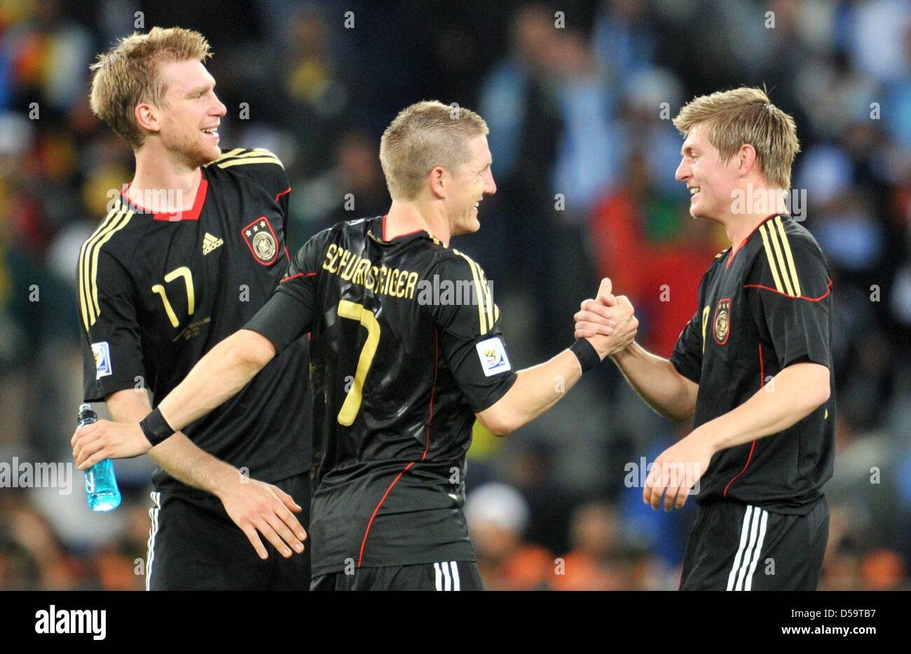 Per Mertesacker (L-R), Bastian Schweinsteiger and Toni Kroos of Germany celebrate after the final whistle of the FIFA World Cup 2010 quarterfinal match between Argentina and Germany at the Green Point Stadium in Cape Town, South Africa 03 July 2010. Photo: Bernd Weissbrod dpa - Please refer to http://dpaq.de/FIFA-WM2010-TC  +++(c) dpa - Bildfunk+++ Stock Photo