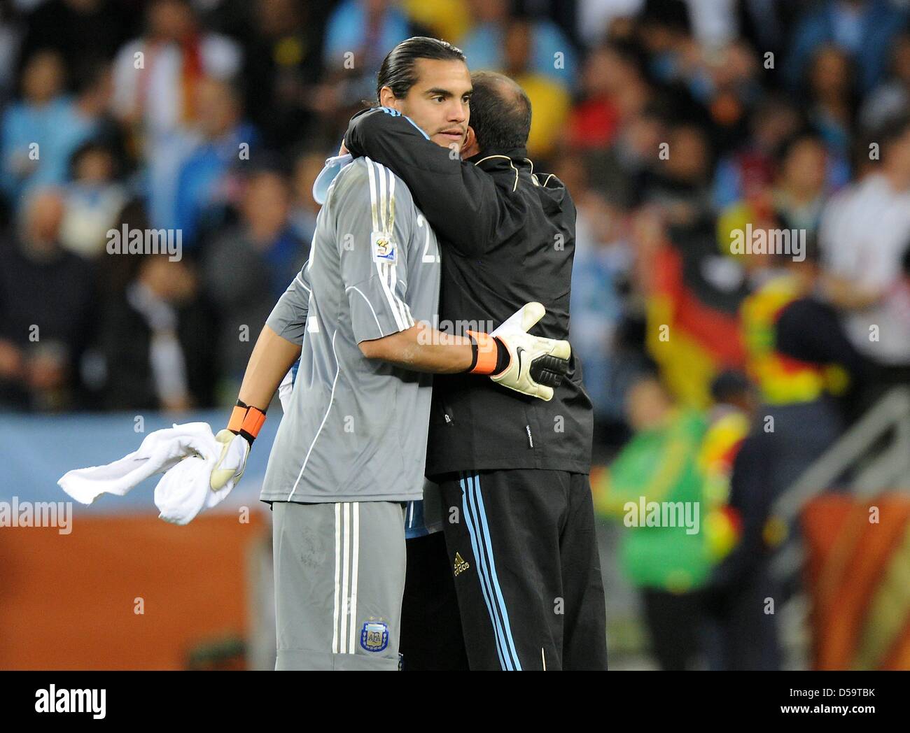 Argentina's goalkeeper Sergio Romero (L) embraces a team mate after the ...