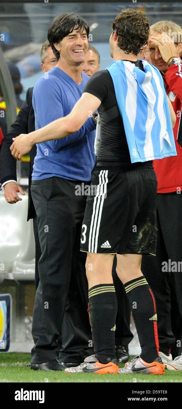 German coach Joachim Loew celebrates with player Arne Friedrich after the 2010 FIFA World Cup quarterfinal match between Argentina and Germany at the Green Point Stadium in Cape Town, South Africa 03 July 2010. Photo: Marcus Brandt dpa - Please refer to http://dpaq.de/FIFA-WM2010-TC Stock Photo