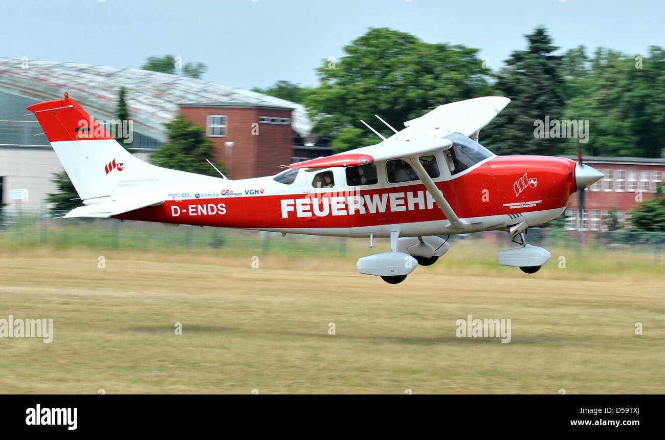 A Cessna 206 lifts off to survey fire hazards at the airfield of Lueneburg, Germany, 02 July 2010. The crew consists of the pilot, a forest ranger and a fireman who will scan the ground for smoke columns. The fire department's air service surveyed  administrative districts Lueneburg, Luechow-Dannenberg, Uelzen, Soltau-Fallingbostel and Harburg from the air because of an increased r Stock Photo