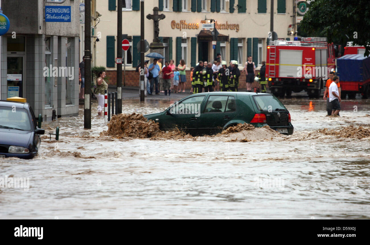 After strong rain showers a car swims in a flooded street in Wachtberg near Bonn, Germany 3 July 2010. Rain storms create chaos almost everywhere in North Rhein-Westphalia. Photo: Maik Exner Stock Photo