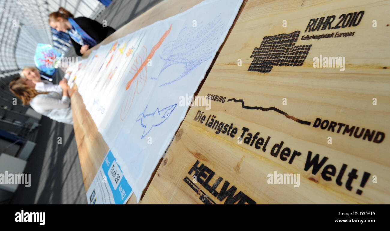 People seated at a portion of the 'world's longest dining table' in a