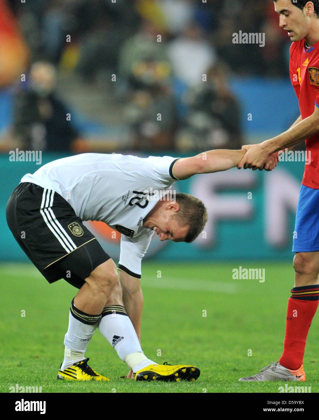 Lukas Podolski (L) of Germany and Sergio Busquets of Spain during the 2010 FIFA World Cup semi-final match between Germany and Spain at the Durban Stadium in Durban, South Africa 07 July 2010. Photo: Bernd Weissbrod dpa - Please refer to http://dpaq.de/FIFA-WM2010-TC  +++(c) dpa - Bildfunk+++ Stock Photo