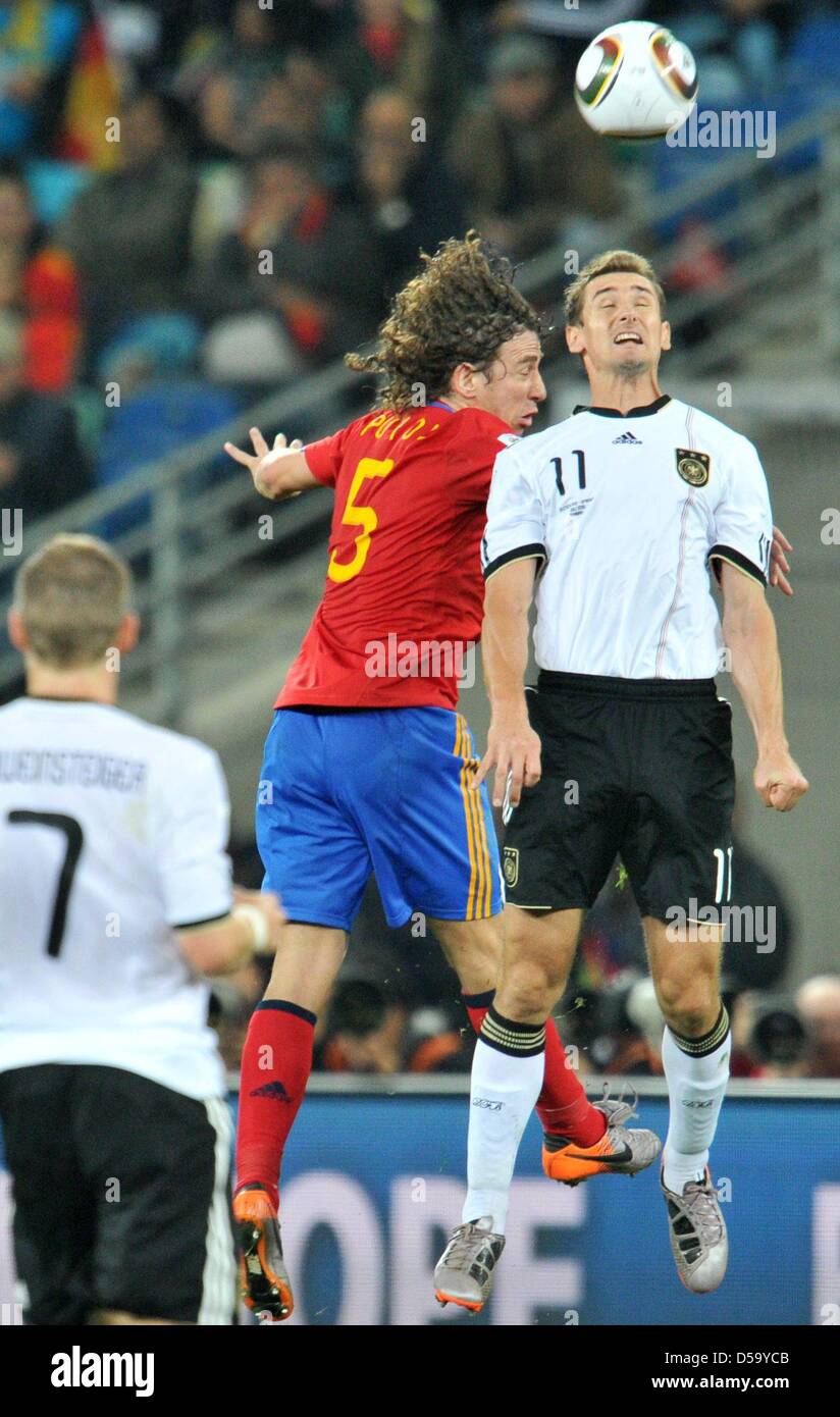 Miroslav Klose (R) of Germany vies with Carles Puyol of Spain during the 2010 FIFA World Cup semi-final match between Germany and Spain at the Durban Stadium in Durban, South Africa 07 July 2010. Photo: Bernd Weissbrod dpa - Please refer to http://dpaq.de/FIFA-WM2010-TC  +++(c) dpa - Bildfunk+++ Stock Photo