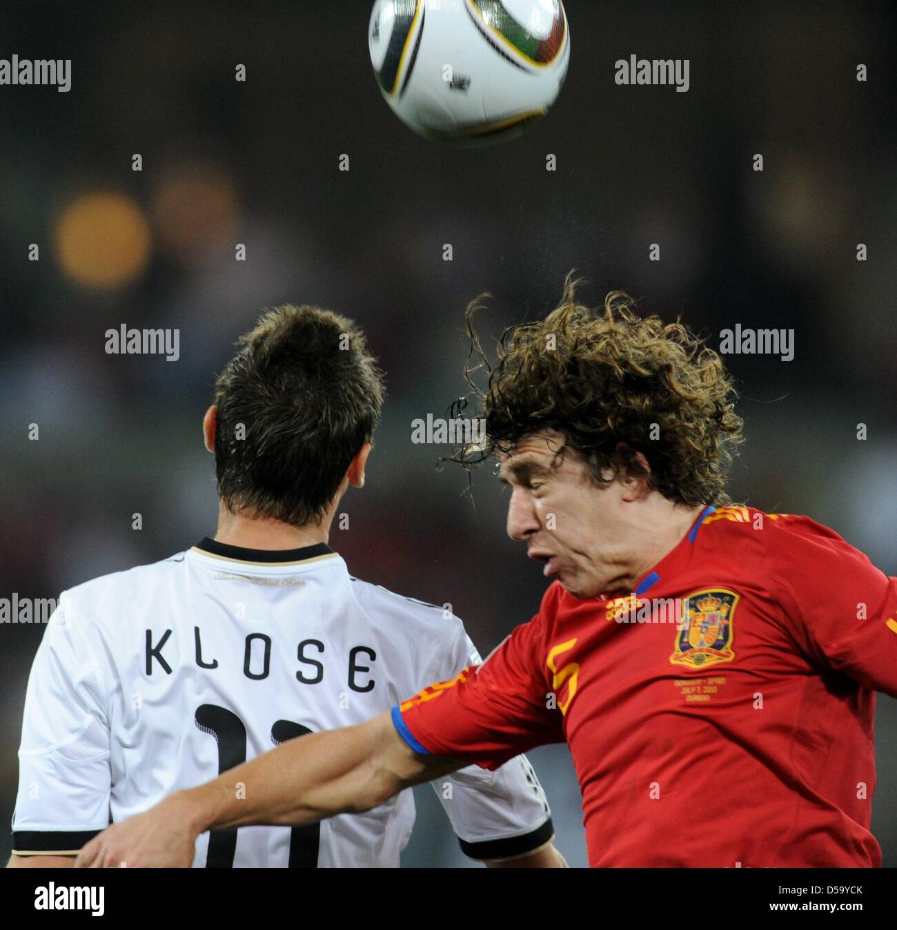 Germany's Miroslav Klose vies for the ball with Spain's Carles Puyol during the 2010 FIFA World Cup semi-final match between Germany and Spain at the Durban Stadium in Durban, South Africa 07 July 2010. Photo: Marcus Brandt dpa - Please refer to http://dpaq.de/FIFA-WM2010-TC Stock Photo