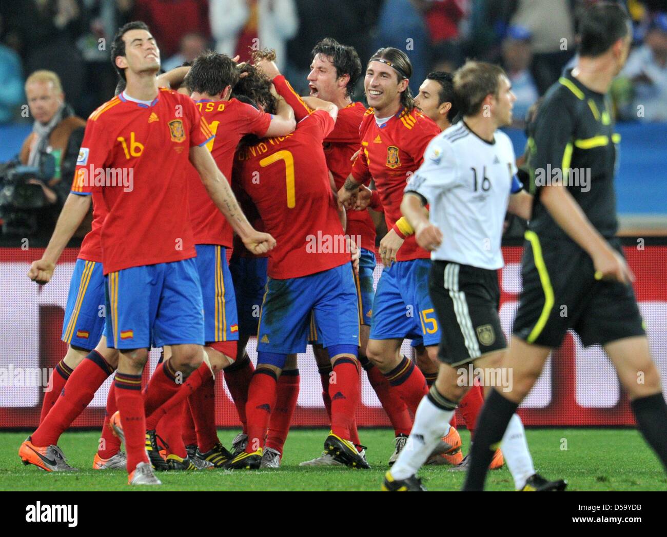 Sergio Busquets (L) of Spain celebrates after Carles Puyol (hidden) scored the 10 during the
