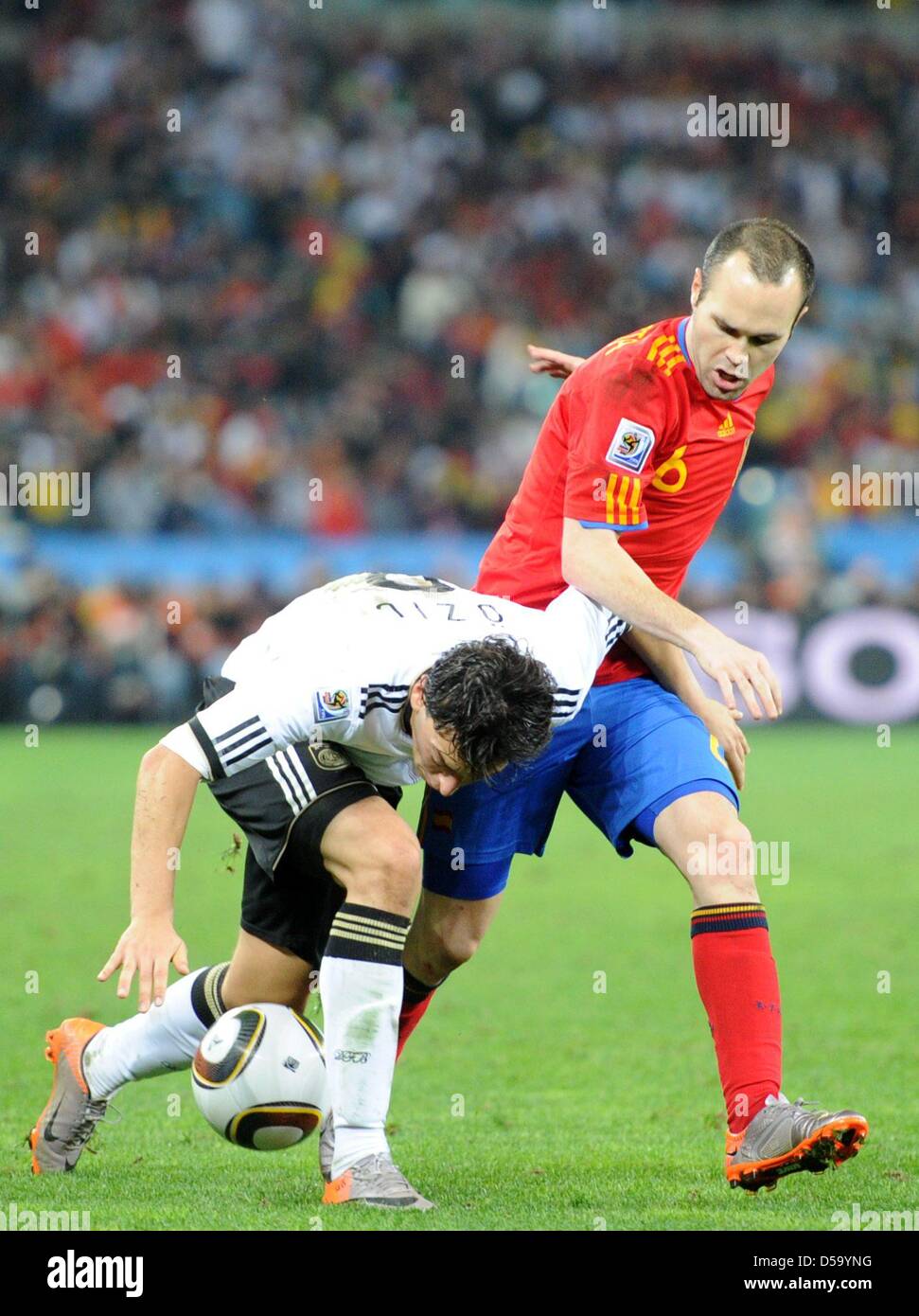 Andres Iniesta (R) of Spain vies with Mesut Oezil of Germany during the 2010 FIFA World Cup semi-final match between Germany and Spain at the Durban Stadium in Durban, South Africa 07 July 2010. Photo: Bernd Weissbrod dpa - Please refer to http://dpaq.de/FIFA-WM2010-TC Stock Photo