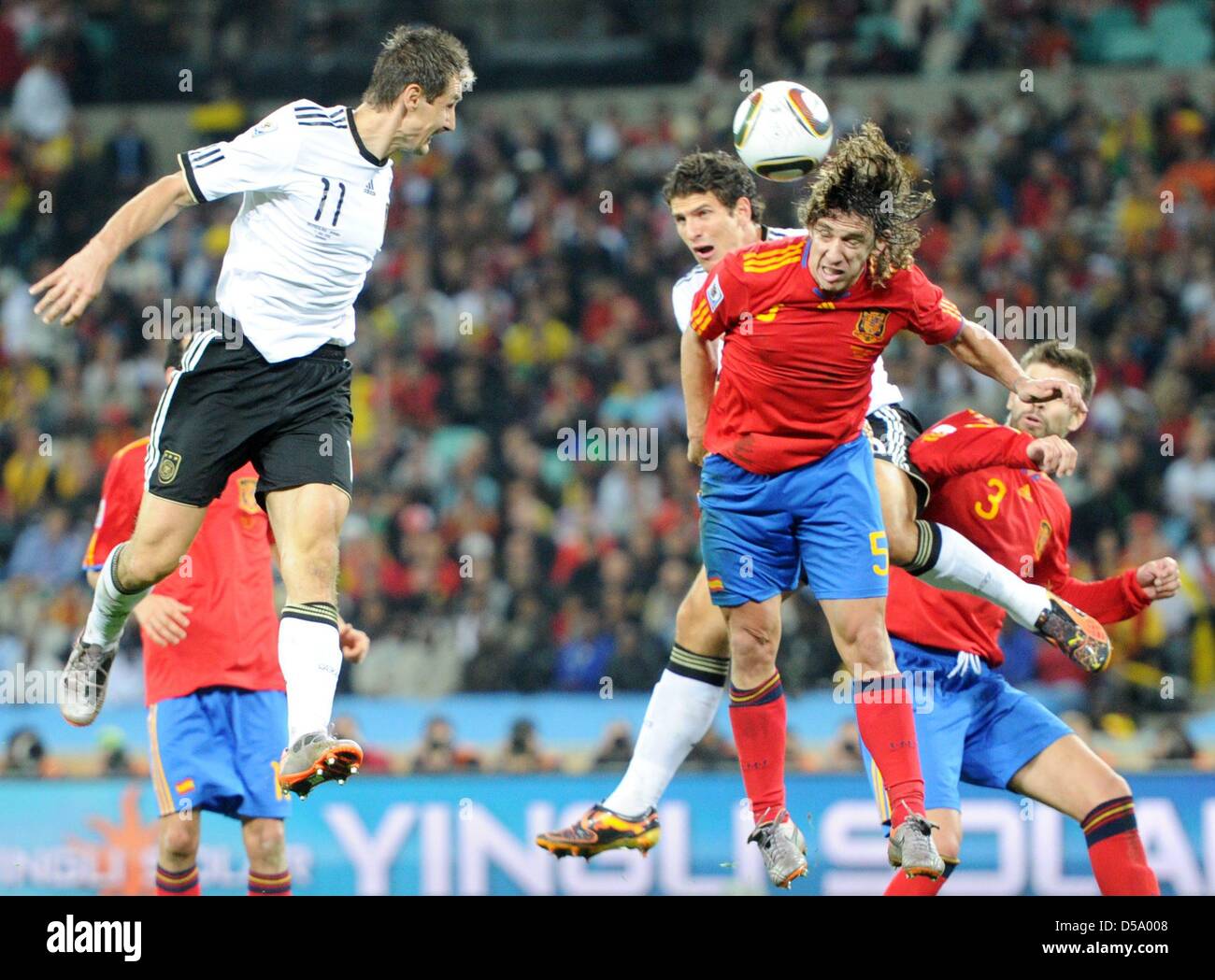 Miroslav Klose (L) of Germany vies with Carles Puyol (R) of Spain during the 2010 FIFA World Cup semi-final match between Germany and Spain at the Durban Stadium in Durban, South Africa 07 July 2010. Photo: Bernd Weissbrod dpa - Please refer to http://dpaq.de/FIFA-WM2010-TC Stock Photo
