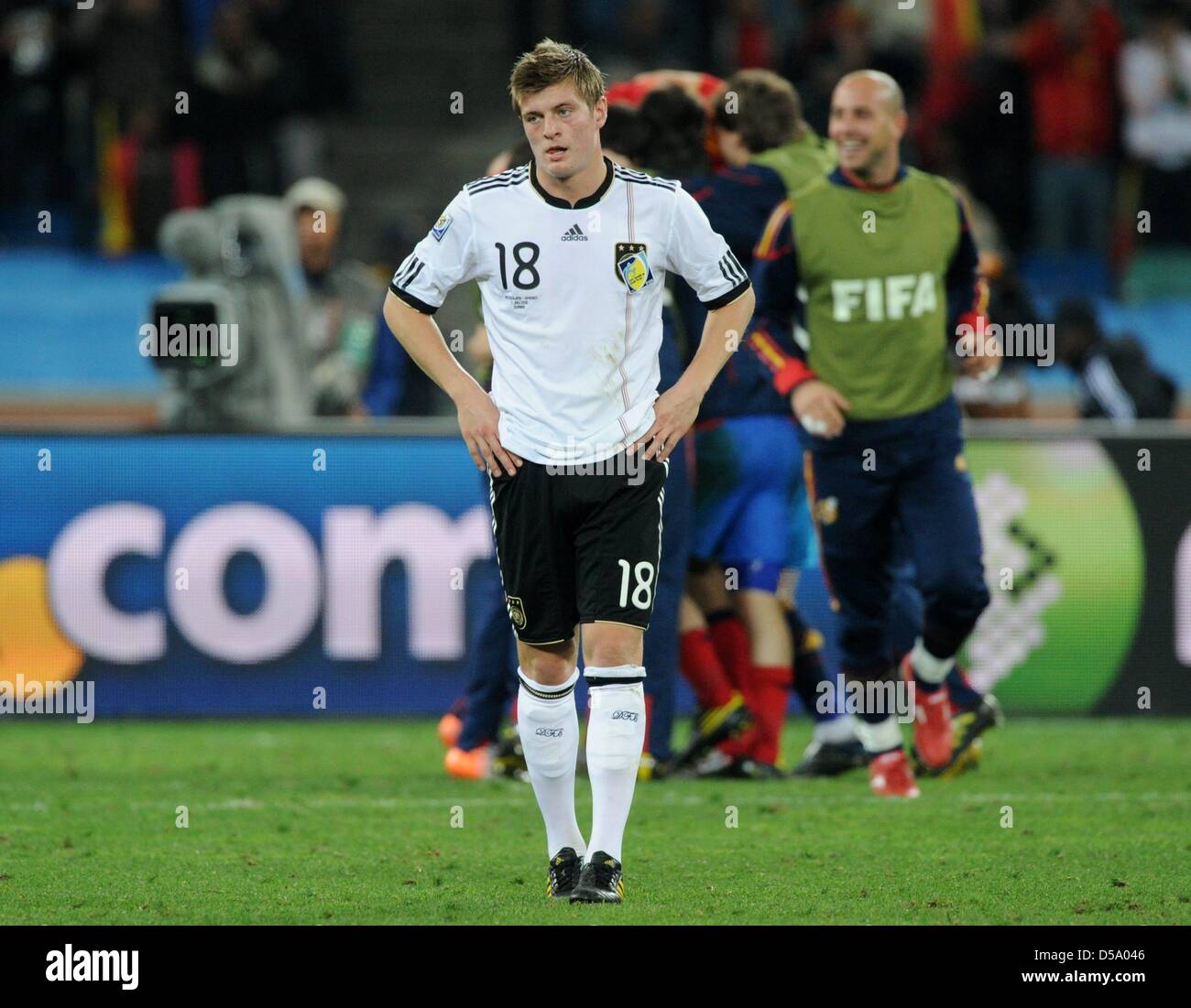 Germany's Toni Kroos walks by celebrating Spaniards after the 2010 FIFA  World Cup semi-final match between Germany and Spain at the Durban Stadium  in Durban, South Africa 07 July 2010. Spain won