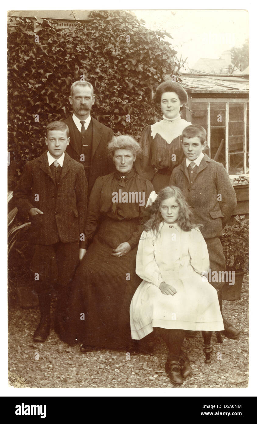 Postcard portrait of a respectable Edwardian family with grandma in their garden, circa 1905, U.K. Stock Photo