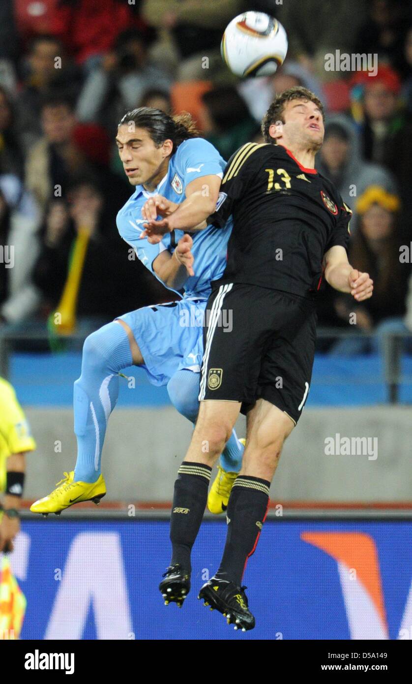 Martin Caceres (L) of Uruguay vies with Thomas Mueller of Germany during the 2010 FIFA World Cup third place match between Uruguay and Germany at the Nelson Mandela Bay Stadium in Port Elizabeth, South Africa 10 July 2010. Photo: Bernd Weissbrod dpa - Please refer to http://dpaq.de/FIFA-WM2010-TC  +++(c) dpa - Bildfunk+++ Stock Photo