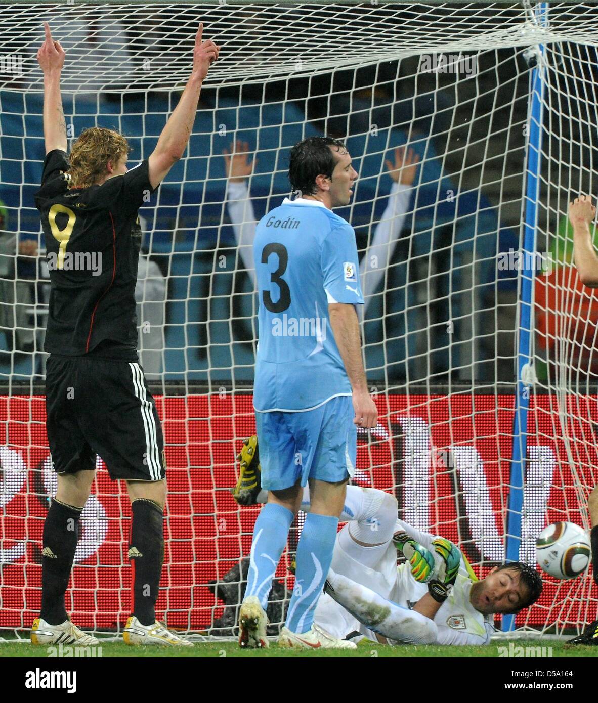 Germany's Stefan Kiessling (L) celebrates after his team mate Sami Khedira (out of picture) scored the 3-2 against Uruguay's goalkeeper Fernando Muslera during the 2010 FIFA World Cup third place match between Uruguay and Germany at the Nelson Mandela Bay Stadium in Port Elizabeth, South Africa 10 July 2010. Photo: Marcus Brandt dpa - Please refer to http://dpaq.de/FIFA-WM2010-TC Stock Photo