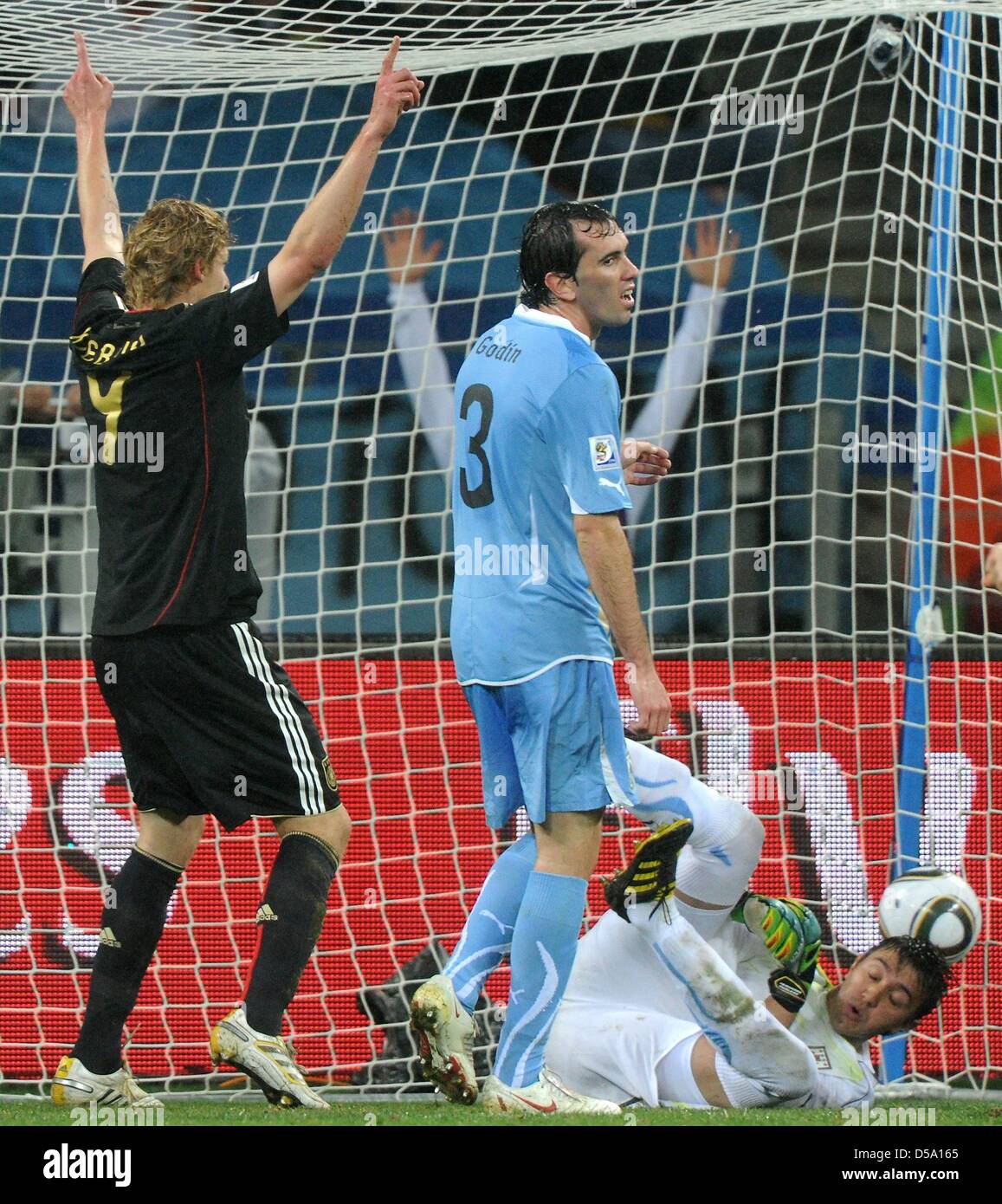 Germany's Stefan Kiessling (L) celebrates after his team mate Sami Khedira (out of picture) scored the 3-2 against Uruguay's goalkeeper Fernando Muslera during the 2010 FIFA World Cup third place match between Uruguay and Germany at the Nelson Mandela Bay Stadium in Port Elizabeth, South Africa 10 July 2010. Photo: Marcus Brandt dpa - Please refer to http://dpaq.de/FIFA-WM2010-TC   Stock Photo