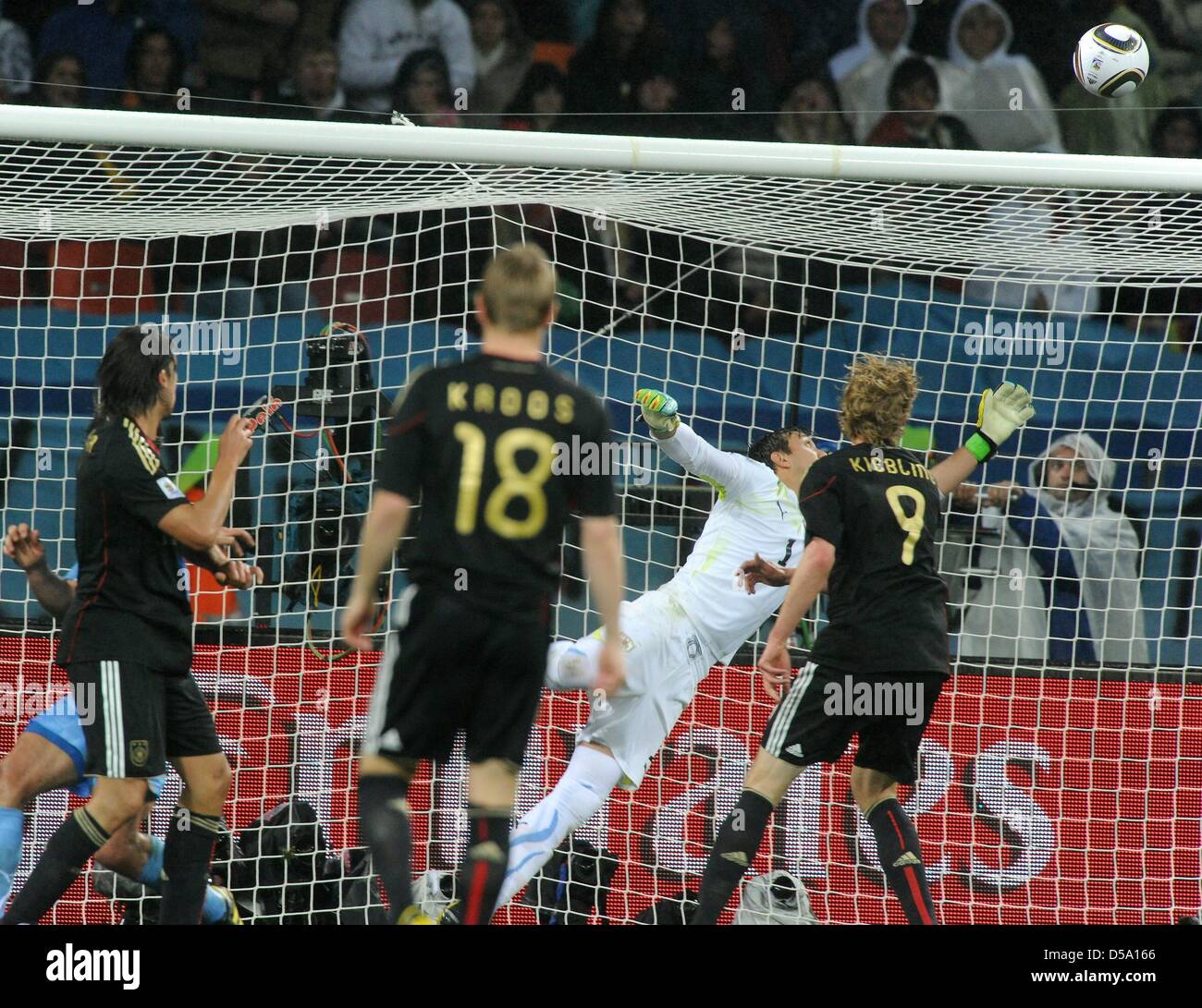 Germany's Sami Khedira (L) scores the 3-2 against Uruguay's goalkeeper Fernando Muslera during the 2010 FIFA World Cup third place match between Uruguay and Germany at the Nelson Mandela Bay Stadium in Port Elizabeth, South Africa 10 July 2010. Photo: Marcus Brandt dpa - Please refer to http://dpaq.de/FIFA-WM2010-TC  +++(c) dpa - Bildfunk+++ Stock Photo