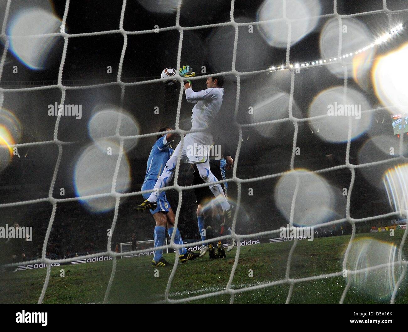 Uruguay's goalkeeper Fernando Muslera (C) goes for the ball during the 2010 FIFA World Cup third place match between Uruguay and Germany at the Nelson Mandela Bay Stadium in Port Elizabeth, South Africa 10 July 2010. Photo: Marcus Brandt dpa - Please refer to http://dpaq.de/FIFA-WM2010-TC  +++(c) dpa - Bildfunk+++ Stock Photo