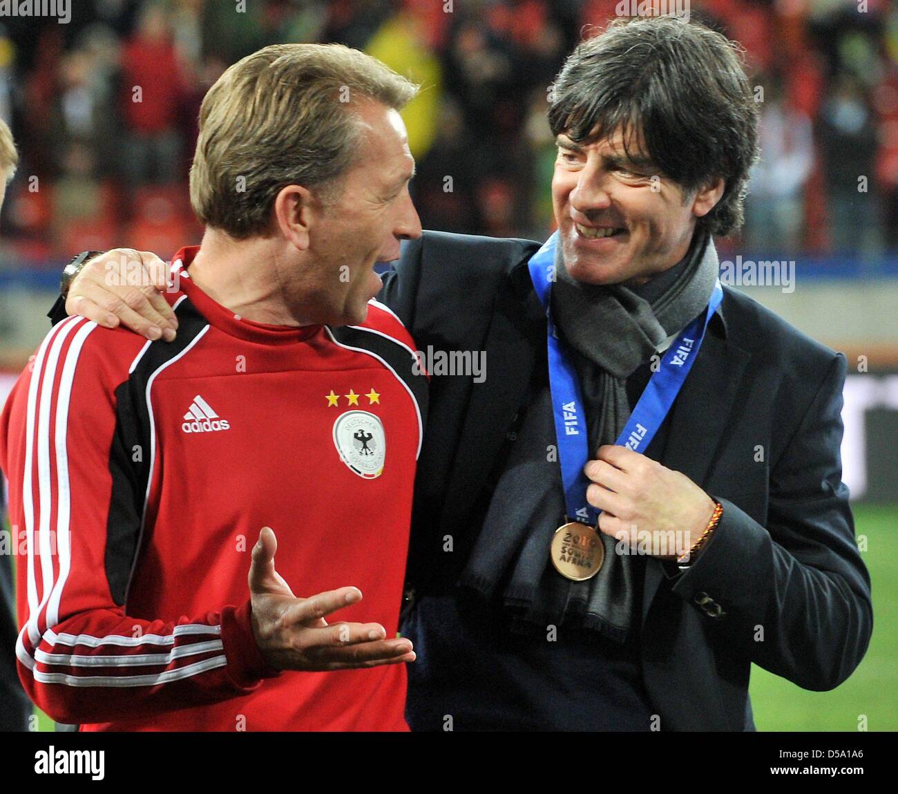 German headcoach Joachim Loew (R) and goalkeeper coach Andreas Koepke celebrate after the 2010 FIFA World Cup third place match between Uruguay and Germany at the Nelson Mandela Bay Stadium in Port Elizabeth, South Africa 10 July 2010. Photo: Bernd Weissbrod dpa - Please refer to http://dpaq.de/FIFA-WM2010-TC  +++(c) dpa - Bildfunk+++ Stock Photo