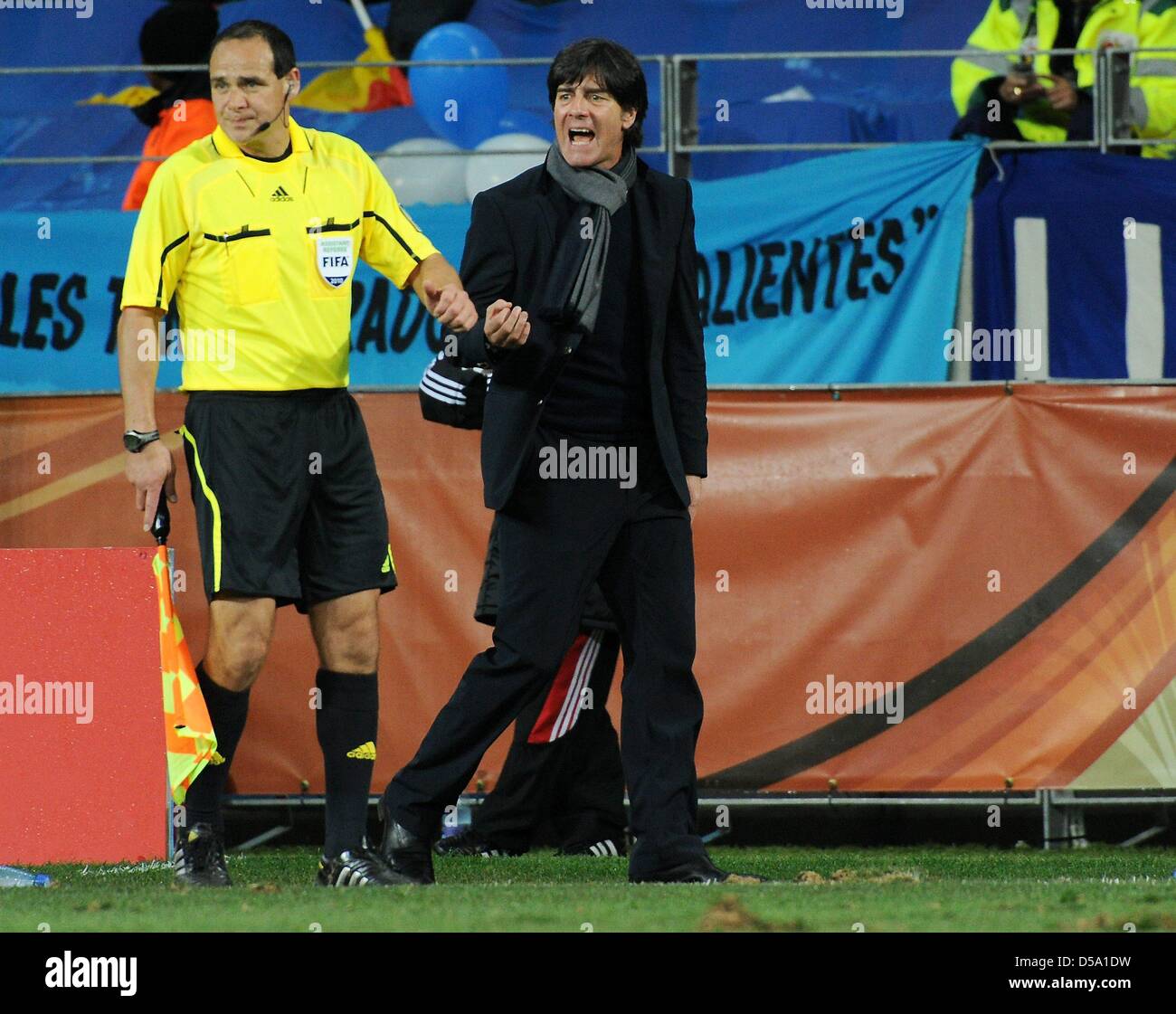 German coach Joachim Loew gestures next to a linesman during the 2010 FIFA World Cup third place match between Uruguay and Germany at the Nelson Mandela Bay Stadium in Port Elizabeth, South Africa 10 July 2010. Germany won 3:2. Photo: Marcus Brandt dpa - Please refer to http://dpaq.de/FIFA-WM2010-TC Stock Photo