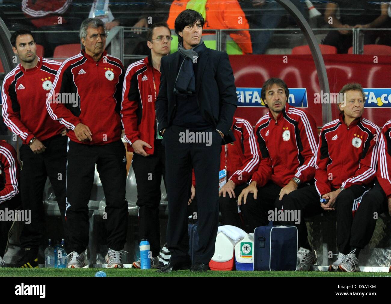 German coach Joachim Loew (C) stands in front of the bench during the 2010 FIFA World Cup third place match between Uruguay and Germany at the Nelson Mandela Bay Stadium in Port Elizabeth, South Africa 10 July 2010. Photo: Marcus Brandt dpa - Please refer to http://dpaq.de/FIFA-WM2010-TC Stock Photo