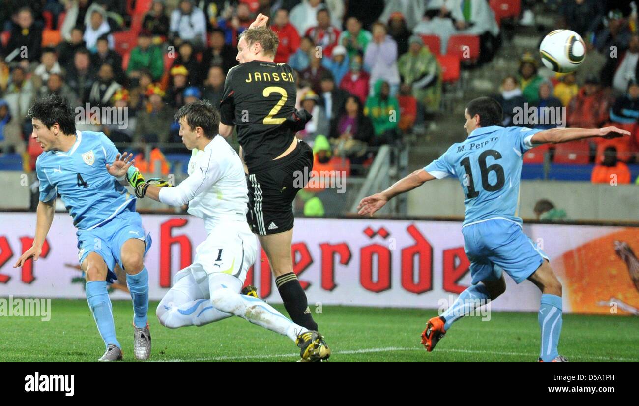 Marcell Jansen (2-R) of Germany scores against Jorge Fucile (L-R), goalkeeper Fernando Muslera and Maximilano Perez during the 2010 FIFA World Cup third place match between Uruguay and Germany at the Nelson Mandela Bay Stadium in Port Elizabeth, South Africa 10 July 2010. Photo: Bernd Weissbrod dpa - Please refer to http://dpaq.de/FIFA-WM2010-TC Stock Photo