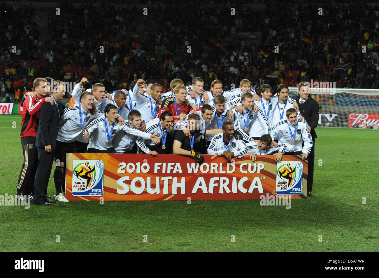 The German team celebrates winning the bronce medal after the 2010 FIFA