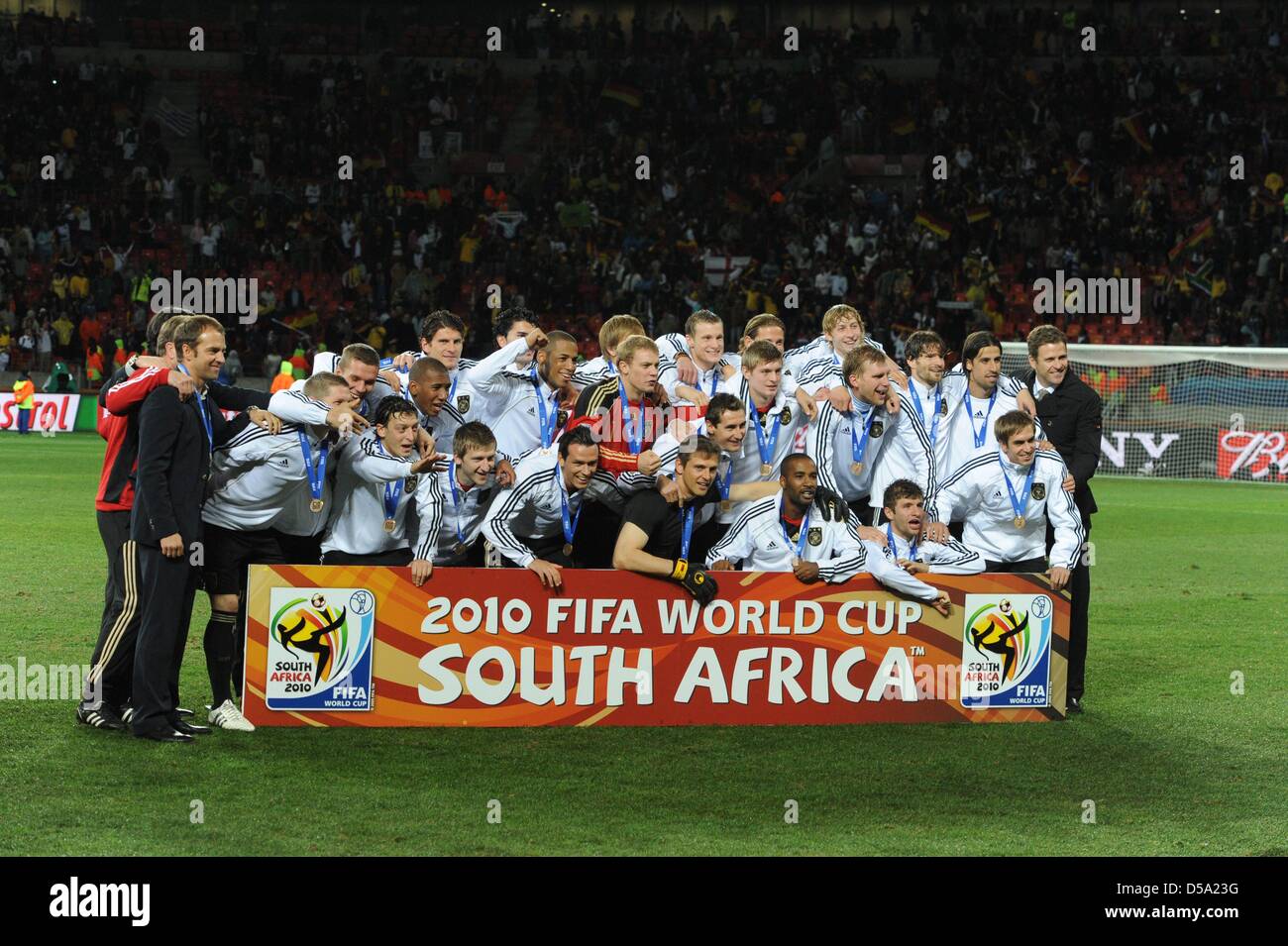 The German team celebrates winning the bronce medal after the 2010 FIFA