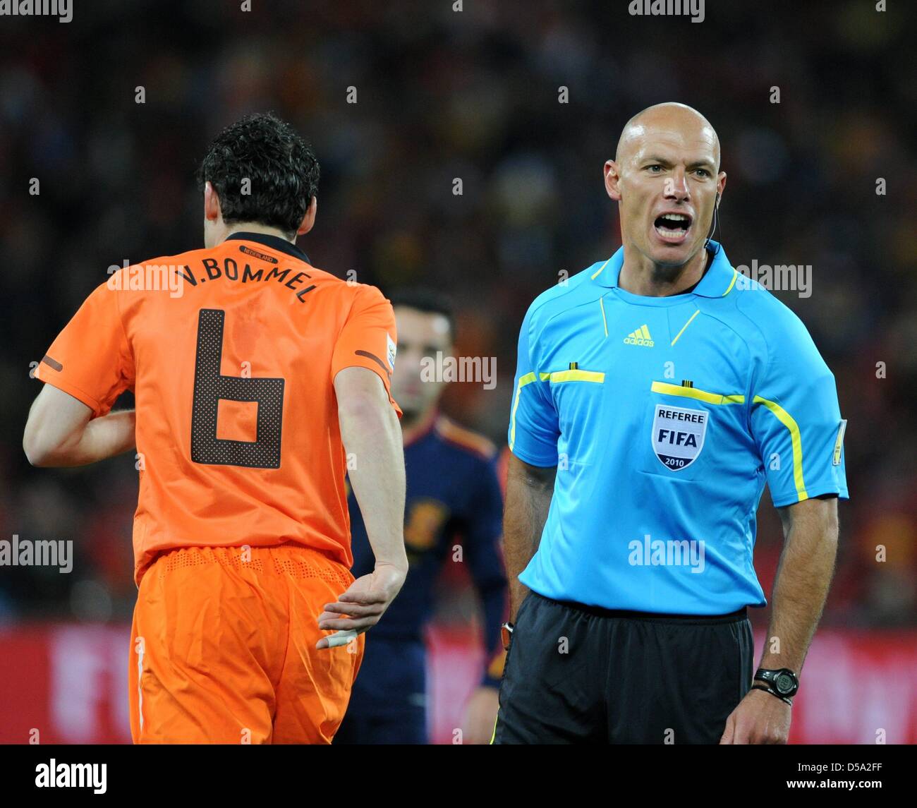 English referee Howard Webb screams next to Dutch Mark van Bommel during  the 2010 FIFA World Cup final match between the Netherlands and Spain at  Soccer City Stadium in Johannesburg, South Africa