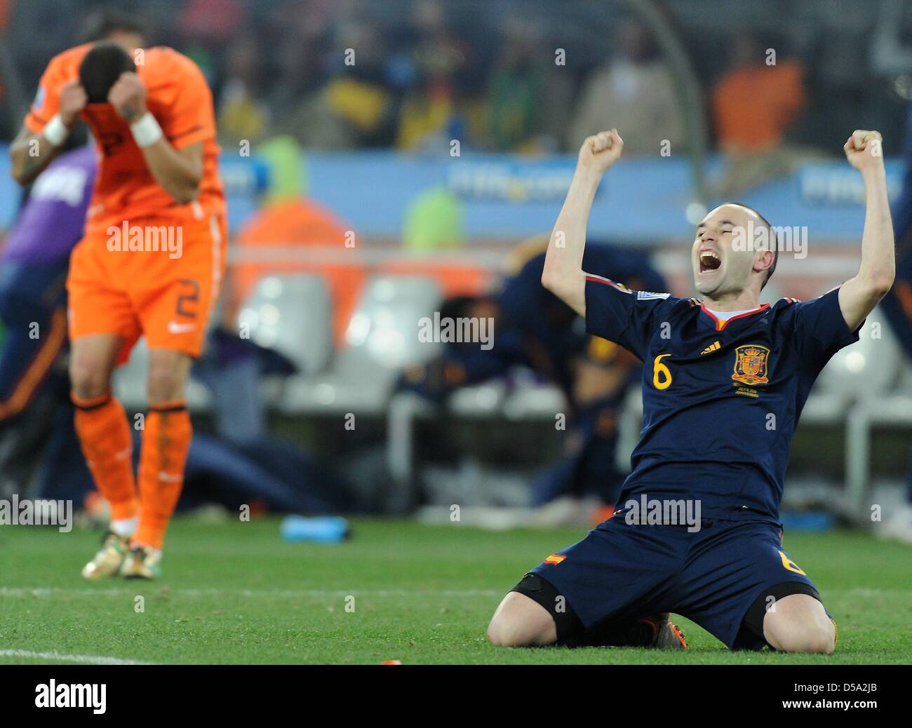 Spain's Andres Iniesta celebrates scoring the 1-0 winning goal as Dutch Gregory van der Wiel is dejected during the 2010 FIFA World Cup final match between the Netherlands and Spain at Soccer City Stadium in Johannesburg, South Africa 11 July 2010. Photo: Marcus Brandt dpa - Please refer to http://dpaq.de/FIFA-WM2010-TC  +++(c) dpa - Bildfunk+++ Stock Photo