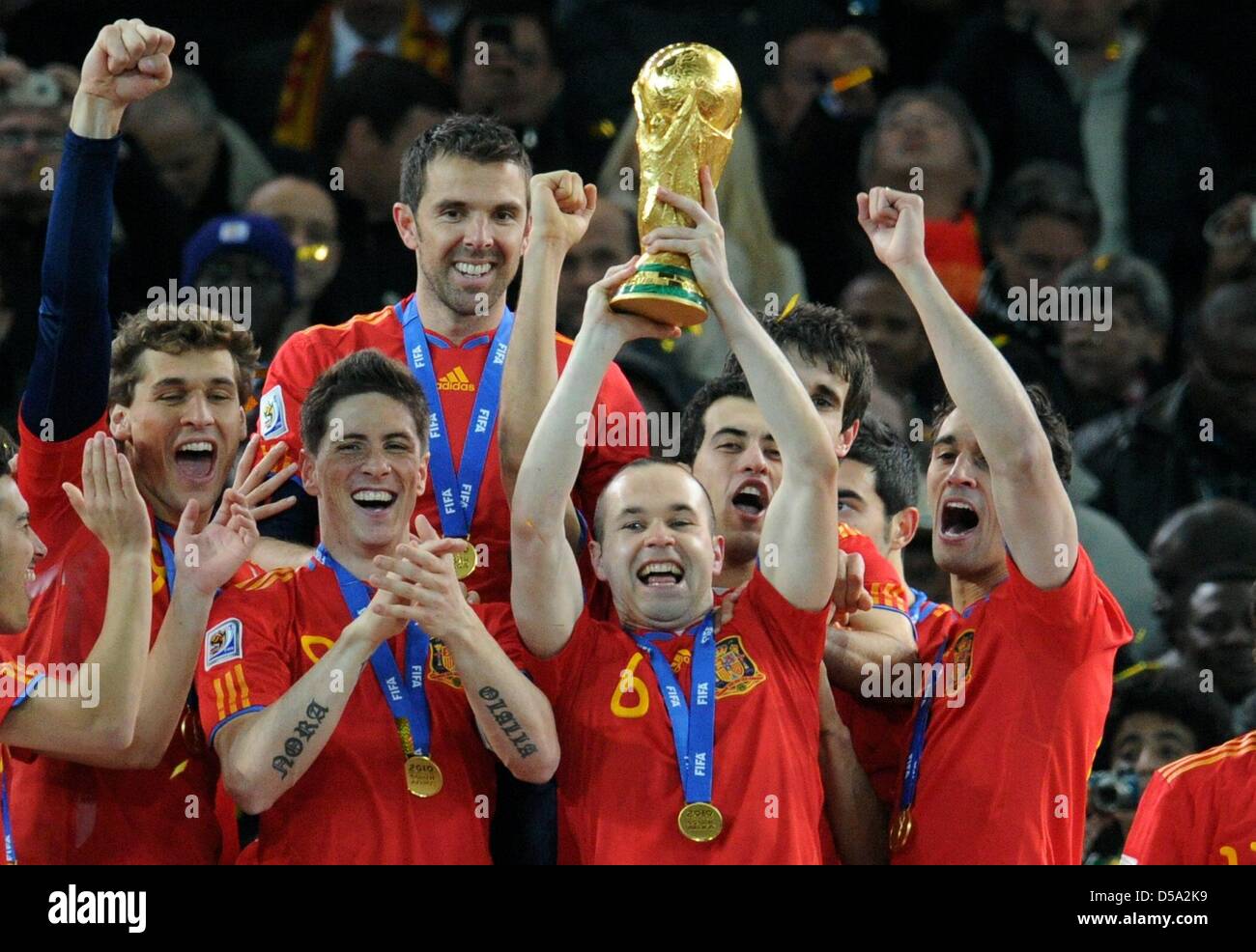 Andres Iniesta (C) of Spain lifts the trophy after the 2010 FIFA World Cup final match between the Netherlands and Spain at the Soccer City Stadium in Johannesburg, South Africa 11 July 2010. Photo: Bernd Weissbrod dpa - Please refer to http://dpaq.de/FIFA-WM2010-TC  +++(c) dpa - Bildfunk+++ Stock Photo