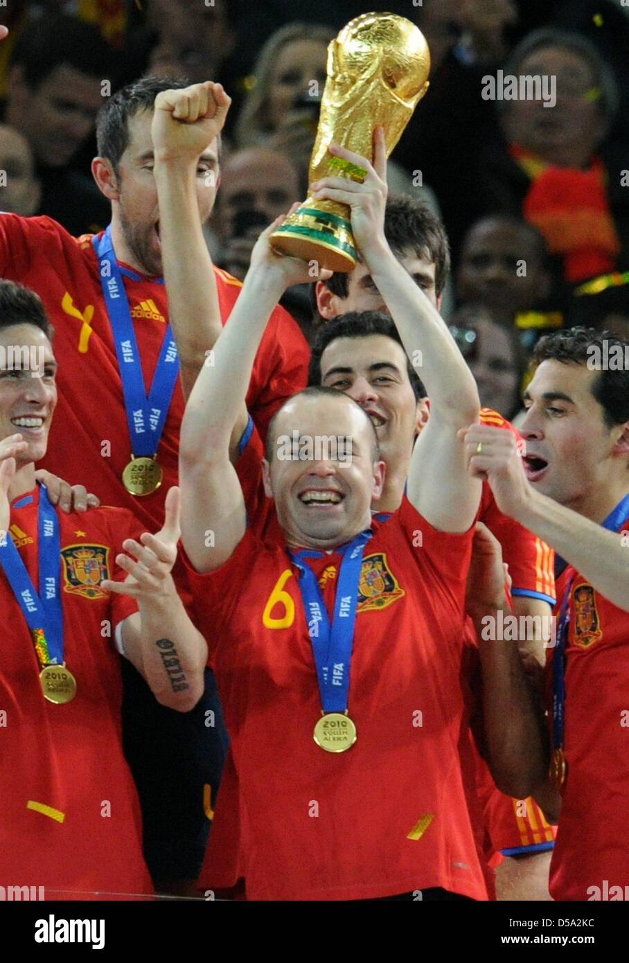 Andres Iniesta of Spain lifts the trophy after the 2010 FIFA World Cup final match between the Netherlands and Spain at the Soccer City Stadium in Johannesburg, South Africa 11 July 2010. Photo: Bernd Weissbrod dpa - Please refer to http://dpaq.de/FIFA-WM2010-TC  +++(c) dpa - Bildfunk+++ Stock Photo