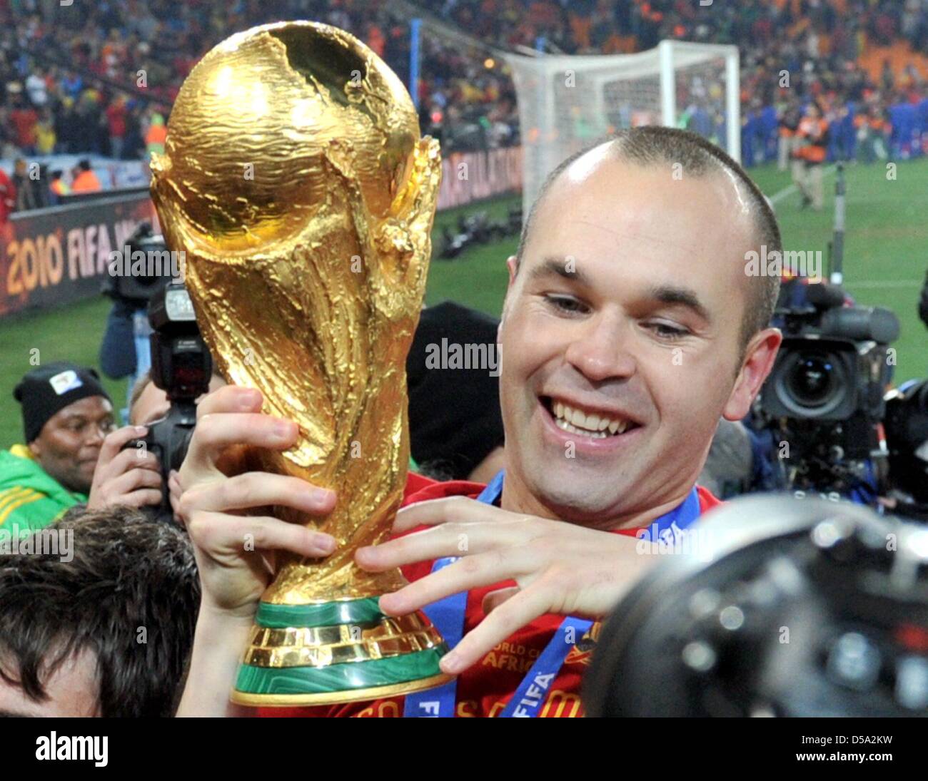 Andres Iniesta of Spain celebrates with the trophy after the 2010 FIFA World Cup final match between the Netherlands and Spain at the Soccer City Stadium in Johannesburg, South Africa 11 July 2010. Photo: Bernd Weissbrod dpa - Please refer to http://dpaq.de/FIFA-WM2010-TC  +++(c) dpa - Bildfunk+++ Stock Photo