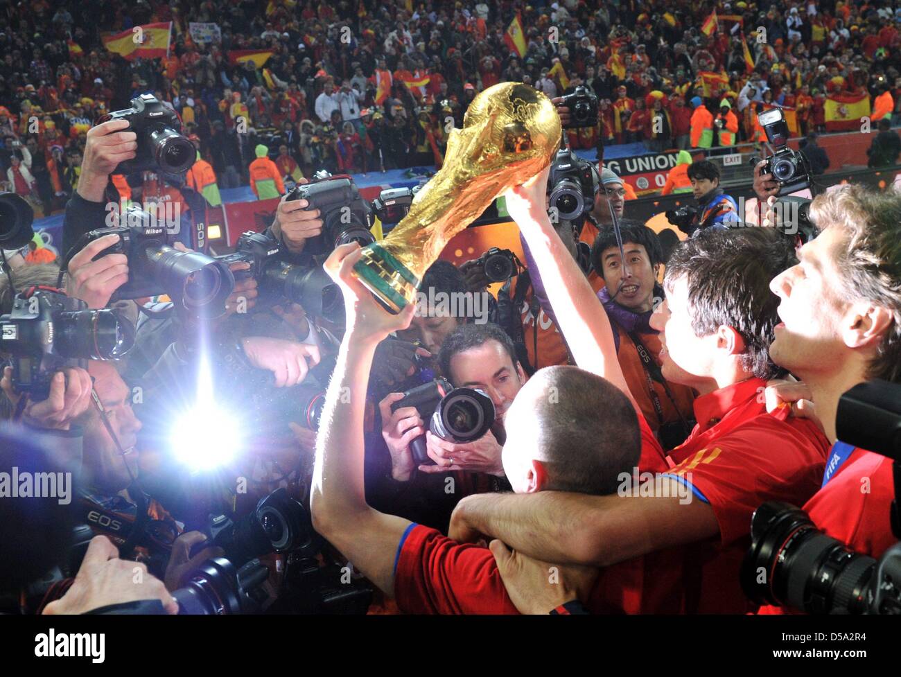 Andres Iniesta celebrates with the trophy after the 2010 FIFA World Cup final match between the Netherlands and Spain at the Soccer City Stadium in Johannesburg, South Africa 11 July 2010. Photo: Bernd Weissbrod dpa - Please refer to http://dpaq.de/FIFA-WM2010-TC  +++(c) dpa - Bildfunk+++ Stock Photo