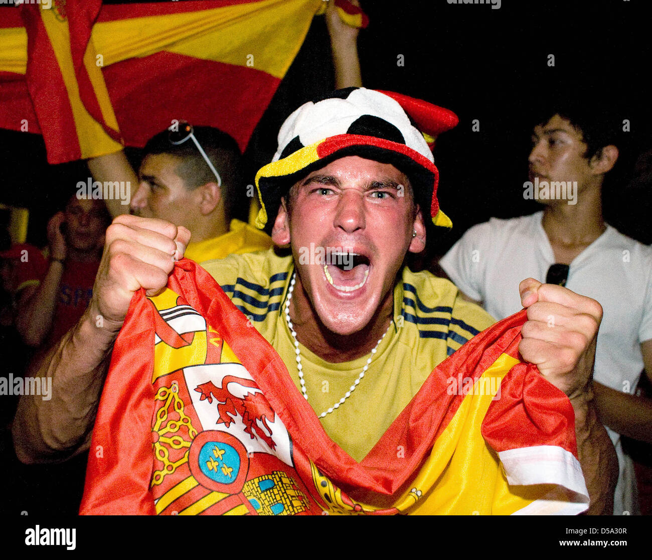 A Spanish fan celebrates the victory-goal of his team during the final match Spain vs. the Netherlands of the 19th FIFA World Cup 2010 in a Spanish quarter - the Ahrbergviertel-in Hannover, Germany, 11 July 2010. Spain won against the Netherlands 1-0 and is World Champion for the first time. Photo: Michael Löwa Stock Photo